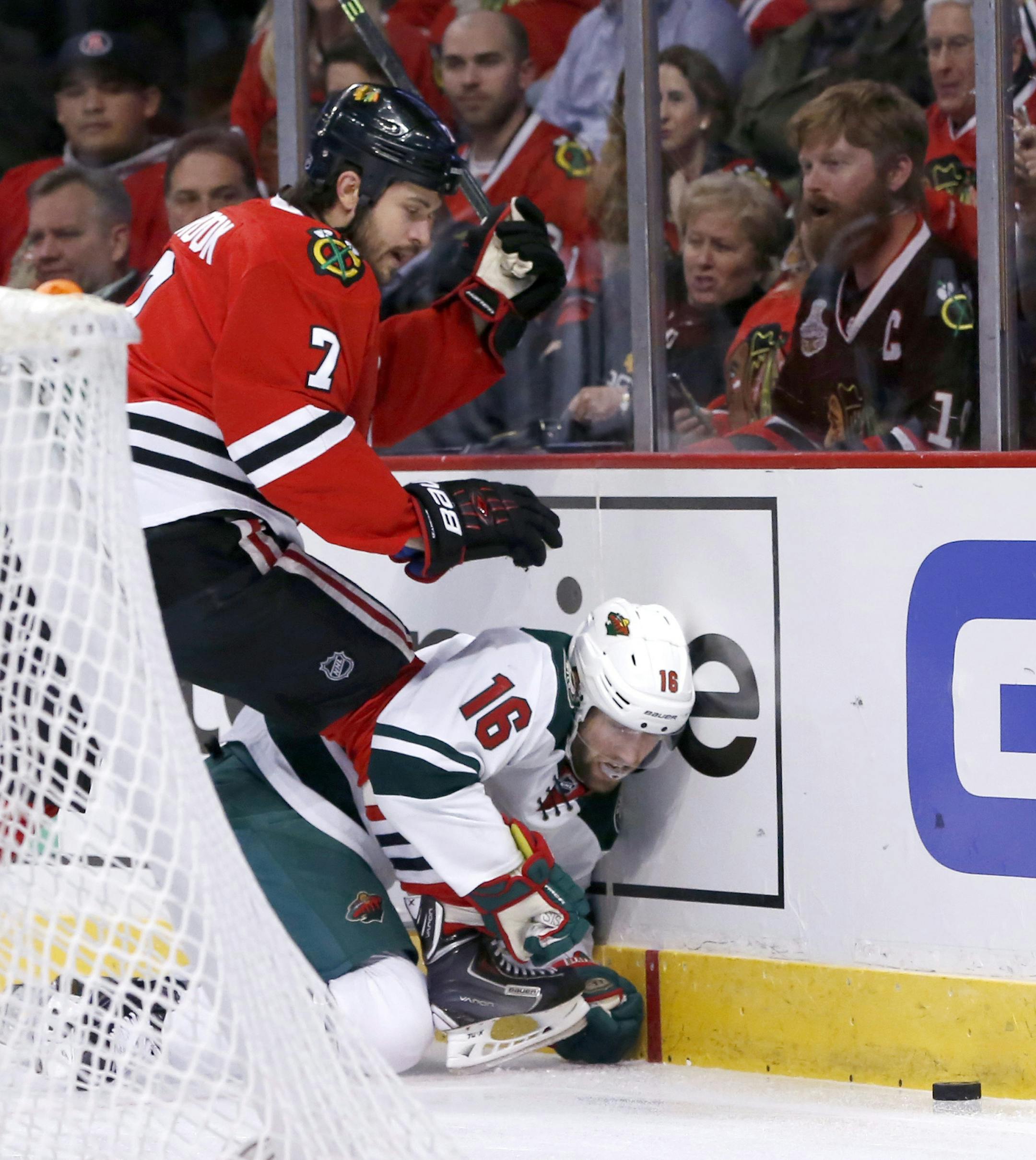 Blackhawks defenseman Brent Seabrook (7) checked Wild left wing Jason Zucker behind the Blackhawks’ net during the first period.