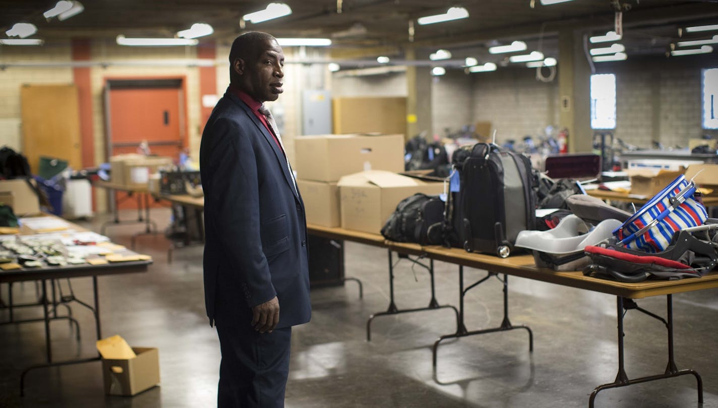 Sgt. Richard Jackson stood next to three long tables full of stolen items recovered from a robbery suspect's home recently. Photographed on Monday, September 14, 2015 in Minneapolis.