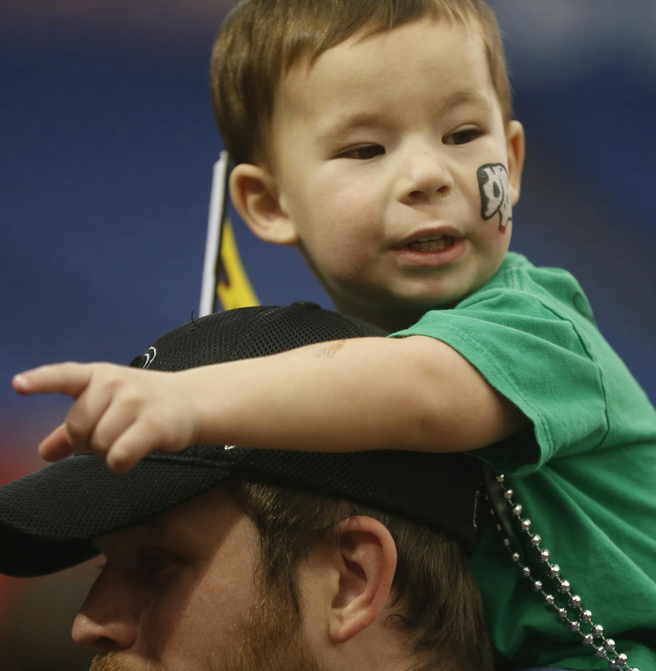 At the Metrodome where the last monster truck rally is being held before the building is demolished, Jacob Button of Rochester,3.5, atop father Kyle came to check out the miniature Traxxas RC cars.]richard tsong-taatarii/rtsong-taatarii@startribune.com