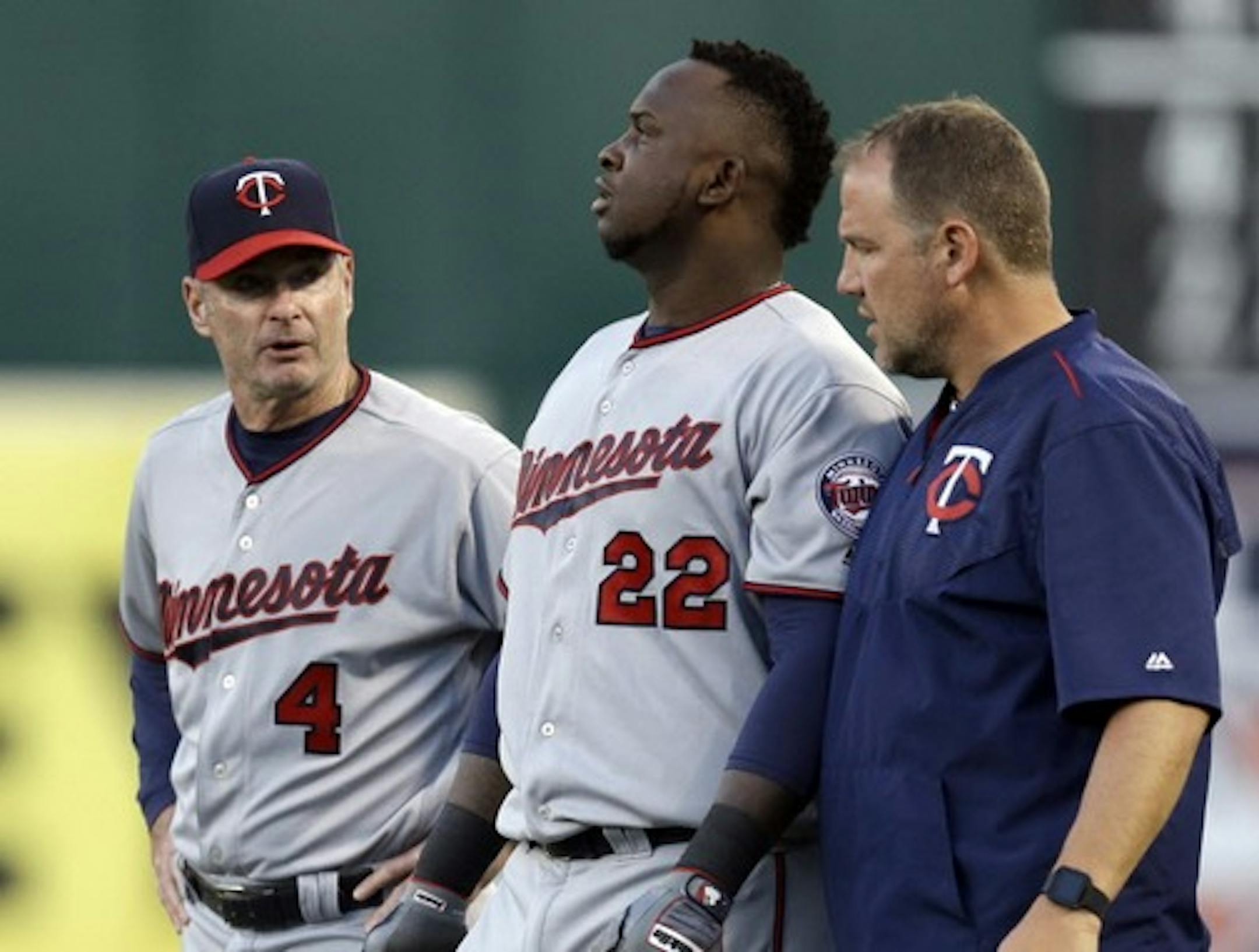 Minnesota Twins manager Paul Molitor, left, and a trainer walk Miguel Sano (22) off the field after an injury sustained in the third inning of a baseball game against the Oakland Athletics Tuesday, May 31, 2016, in Oakland, Calif. Sano left the game. (AP Photo/Ben Margot)