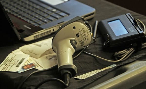 A voter ID scanning device made by Datacard Group. The system includes a scanner, left, digital signiture pad with stylus and a computer to input vote