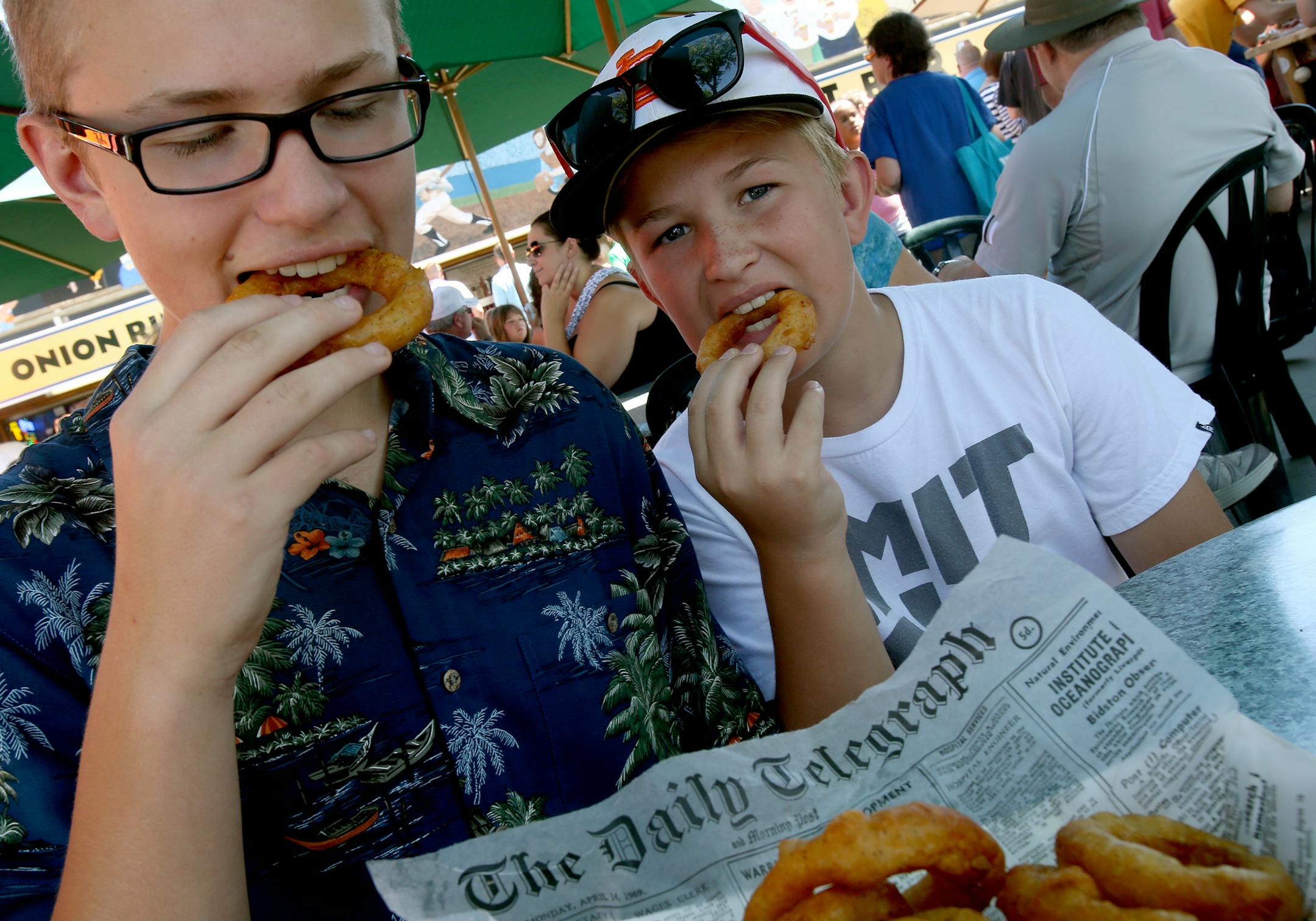 Mike Collins (left) and Tim Collins of St. Louis Park eat onion rings at the Ball Park Cafe booth at the Minnesota State Fair in St. Paul, MN on August 22, 2013. ] JOELKOYAMA‚Ä¢joel koyama@startribune