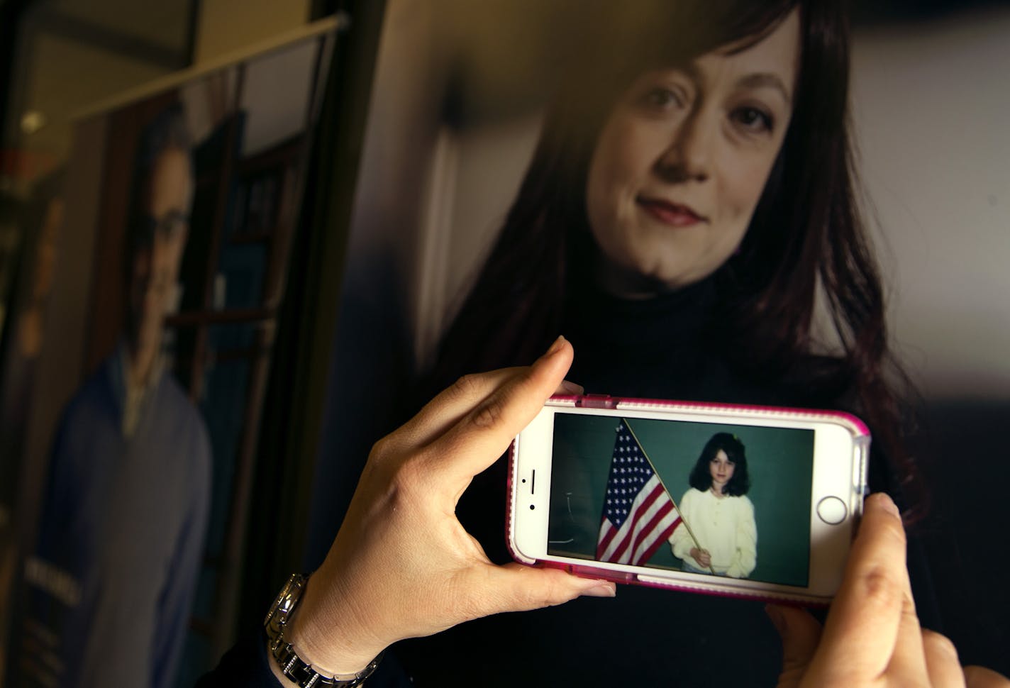 Tea Rozman-Clark, executive director of Green Card Voices watched a interactive video on Irene Ruderman Clark, who was born in Belarus, at the exhibition of stories from Green Card Voices on display at Saint Paul College.