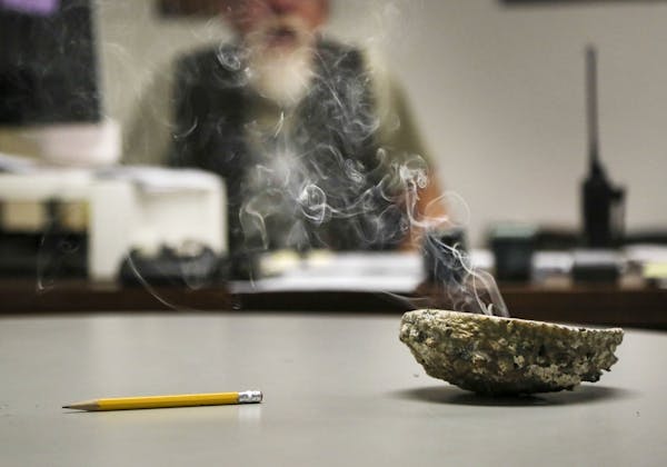 Smokes billows from burning sage in a conch shell in the office of Gerry Hoyum, Bug-O-Nay-Ge-Shig High School vice principal and dean of students Tues