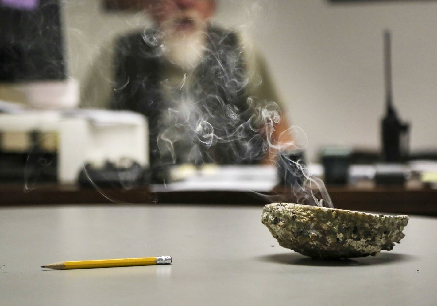 Smokes billows from burning sage in a conch shell in the office of Gerry Hoyum, Bug-O-Nay-Ge-Shig High School vice principal and dean of students Tuesday, Sept. 9, 2014. Hoyum said the smell of burning sage, which is a part of the Ojibwe culture, can be soothing for students and he, at times, burns it when he is bringing together students embroiled in conflict to help them work out their differences.](DAVID JOLES/STARTRIBUNE)djoles@startribune The Bug O Nay Ge Shig School is a culturally based a