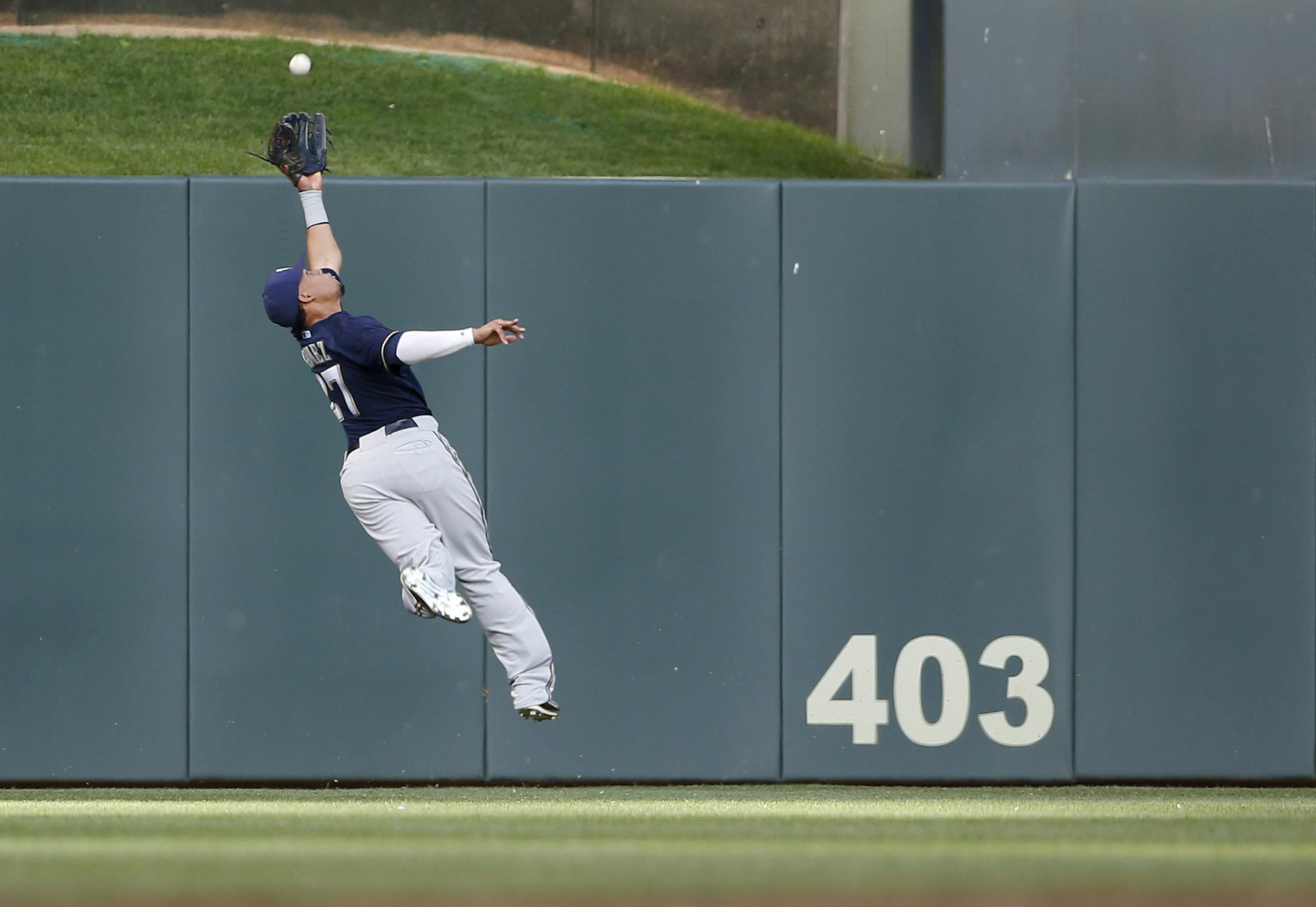 Carlos Gomez of the Milwaukee Brewers leaped through the air to make a catch on a fly ball from Torii Hunter during the first inning.