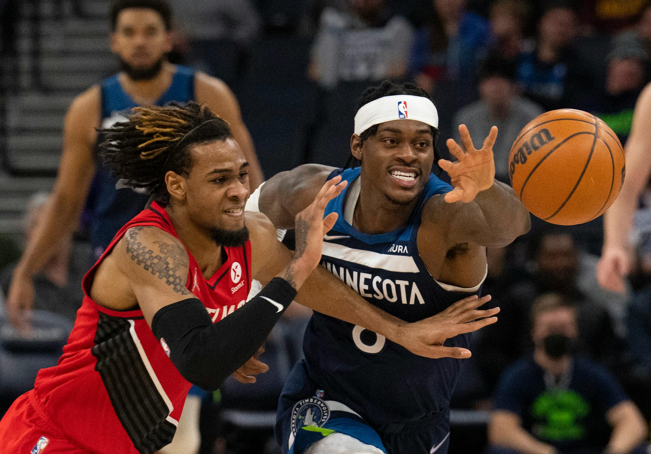 Minnesota Timberwolves forward Jarred Vanderbilt (8) and Portland Trail Blazers forward Greg Brown III (4) chased a loose ball in the second quarter.