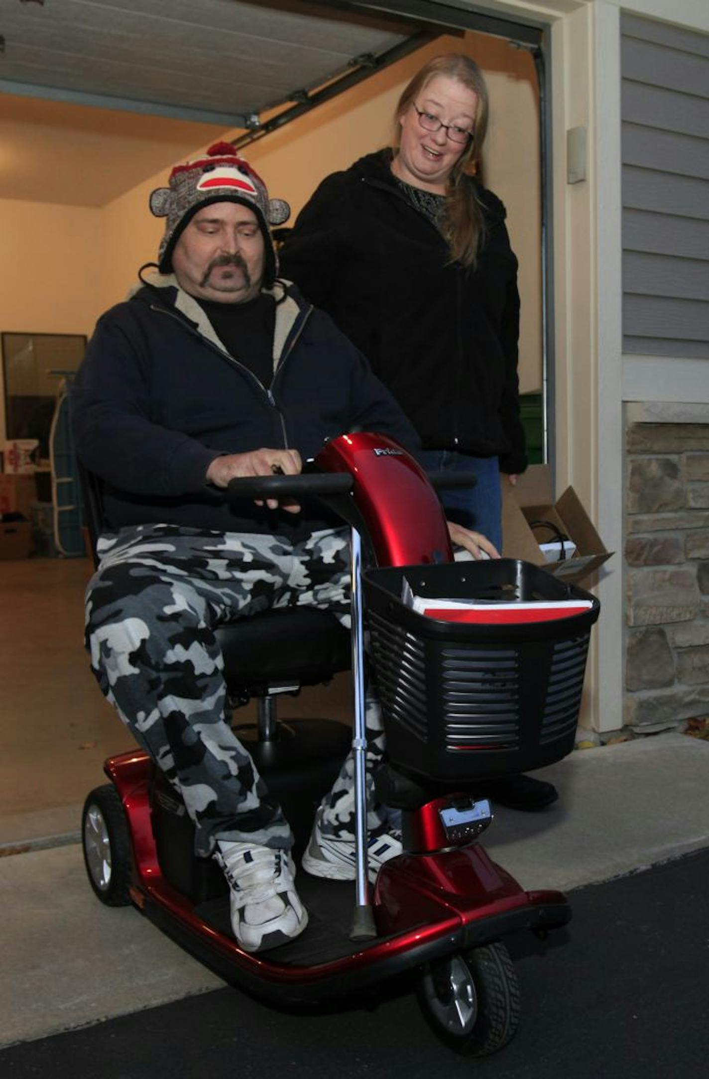 George Hensley and Heidi Johnson picked up a scooter that the law firm Schwebel, Goetz & Sieben bought to replace the one that was stolen.