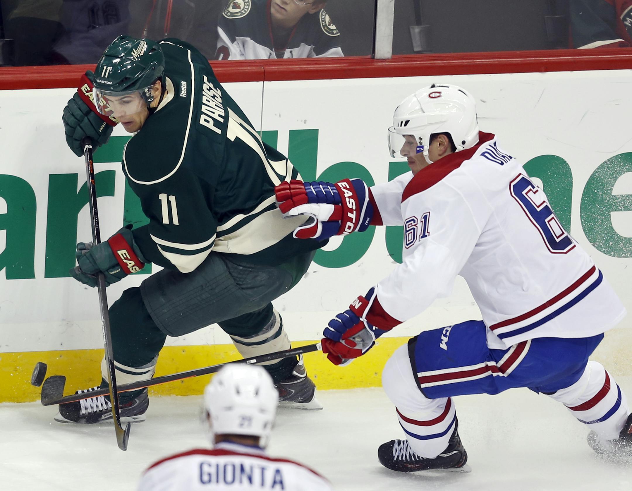 Montreal’s Raphael Diaz (61) chases the Minnesota Wild’s Zach Parise (11) during first period action Friday, Nov. 1, 2013, at the Xcel Energy Center in St. Paul.