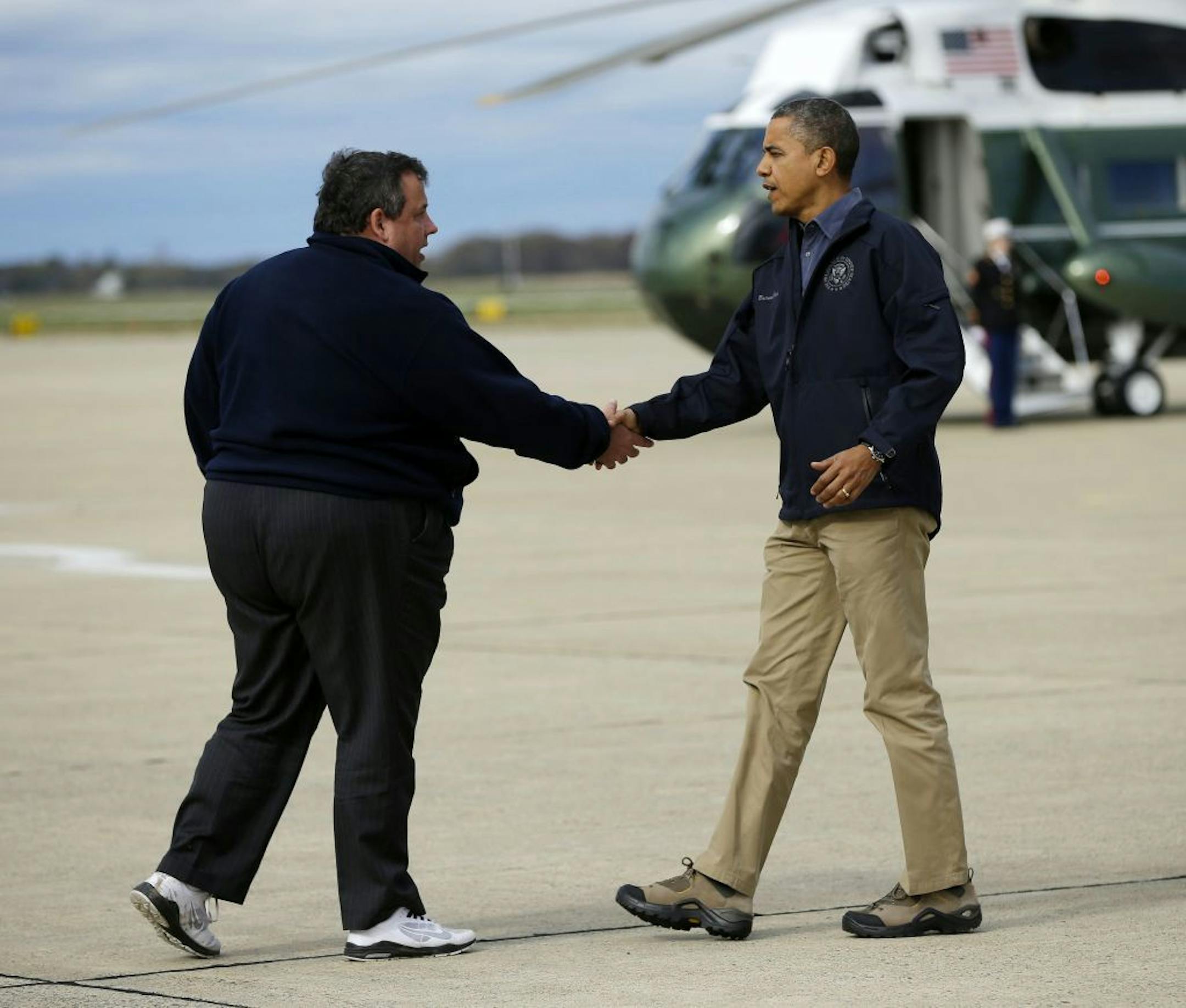 President Barack Obama is greeted by New Jersey Gov. Chris Christie upon his arrival at Atlantic City International Airport, Wednesday, Oct. 31, 2012, in Atlantic City. Obama traveled to region to take an aerial tour of the Atlantic Coast over areas damaged by superstorm Sandy,