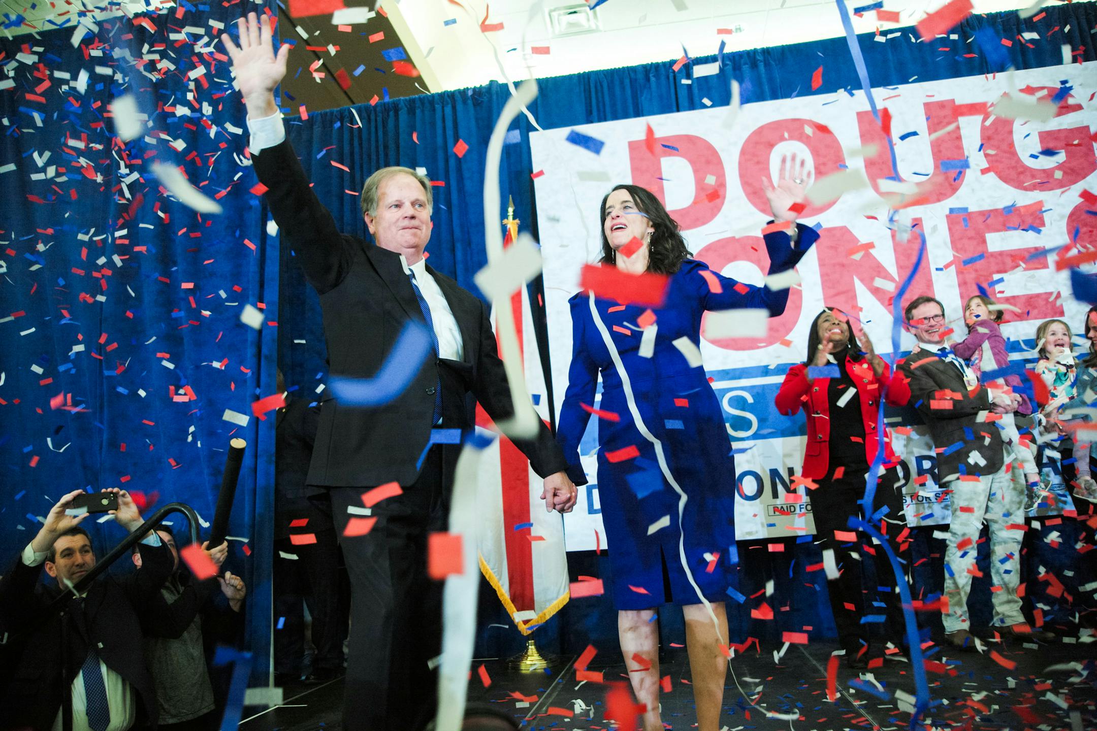 Doug Jones, the Democratic candidate for U.S. Senate, is accompanied by his wife, Louise, at an Election Night gathering of his supporters in Birmingham, Ala., on Dec. 12, 2017. Jones, a former prosecutor who mounted a seemingly quixotic campaign in the face of Republican dominance here, defeated his scandal-scarred opponent, Roy Moore, after a brutal campaign marked by accusations of sexual abuse and child molestation against the Republican. (Bob Miller/The New York Times)