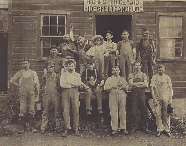 In this 1900-era photo of the Uber family tannery in Hartford, WI, three of the four sons of Carl Gottlieb Uber are shown. First row, fourth from left