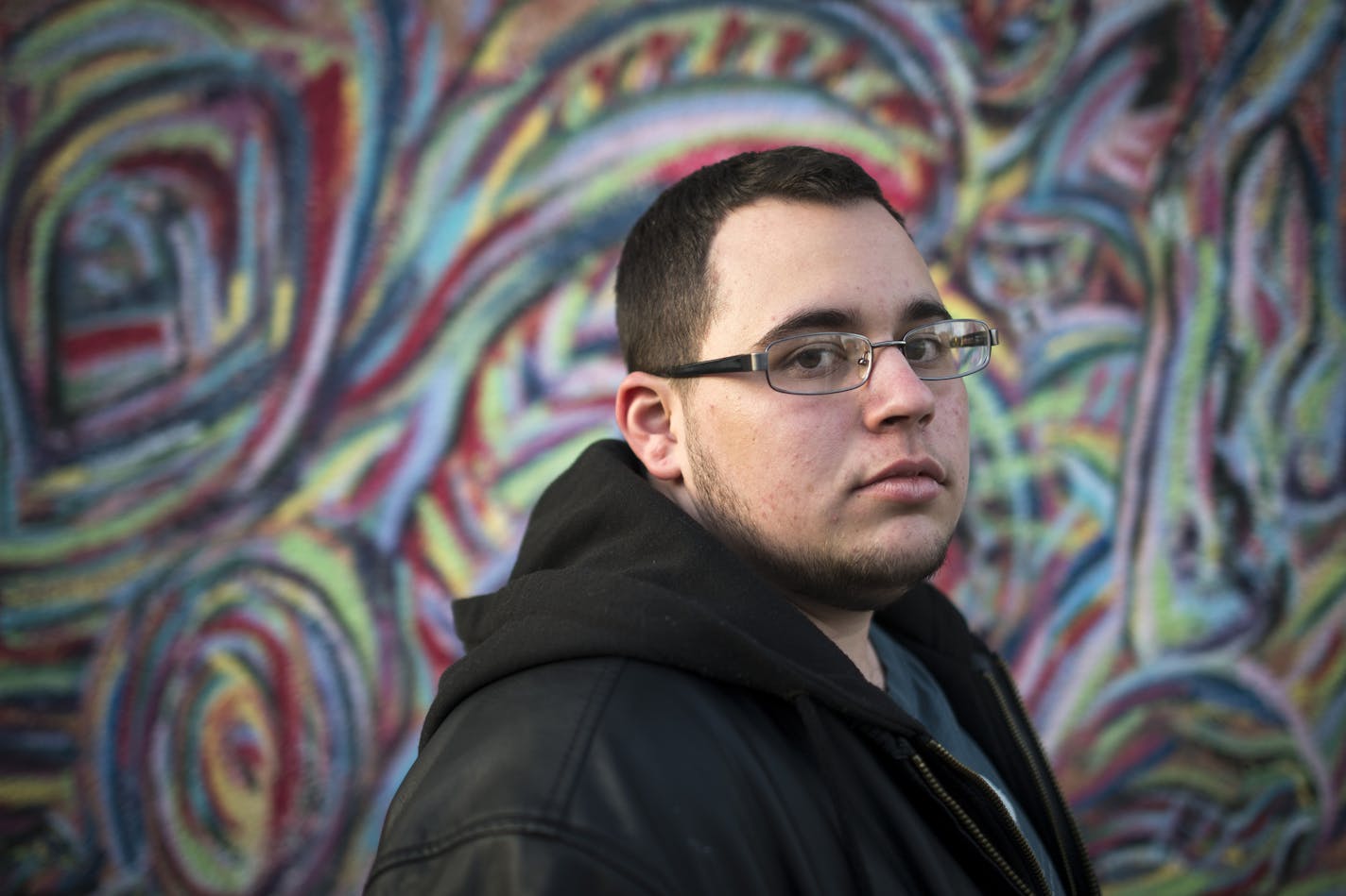 Jakob Rumble stands in front of a mural for a portrait outside of Cafe Southside on Tuesday afternoon. ] (Aaron Lavinsky | StarTribune) Jakob Rumble was in extreme pain when he showed up a Southdale Medical Center in June of 2013. He describes himself as a "female-to-male trans gender man" and his labia had swollen to nearly three times its normal size. But he claims in a federal law lawsuit that he was treated with hostility by the emergency room physician who asked him if "he'd ever had sex wi