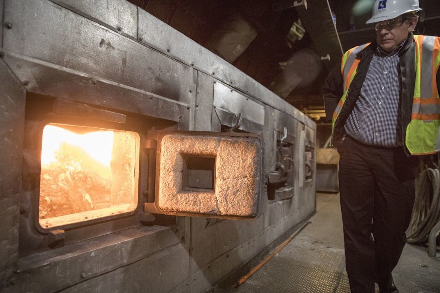 Tim Steinbeck, director of Great River Energy's Elk River Resource Processing Plant and Recovery Station, peered into a boiler burning trash to generate energy.