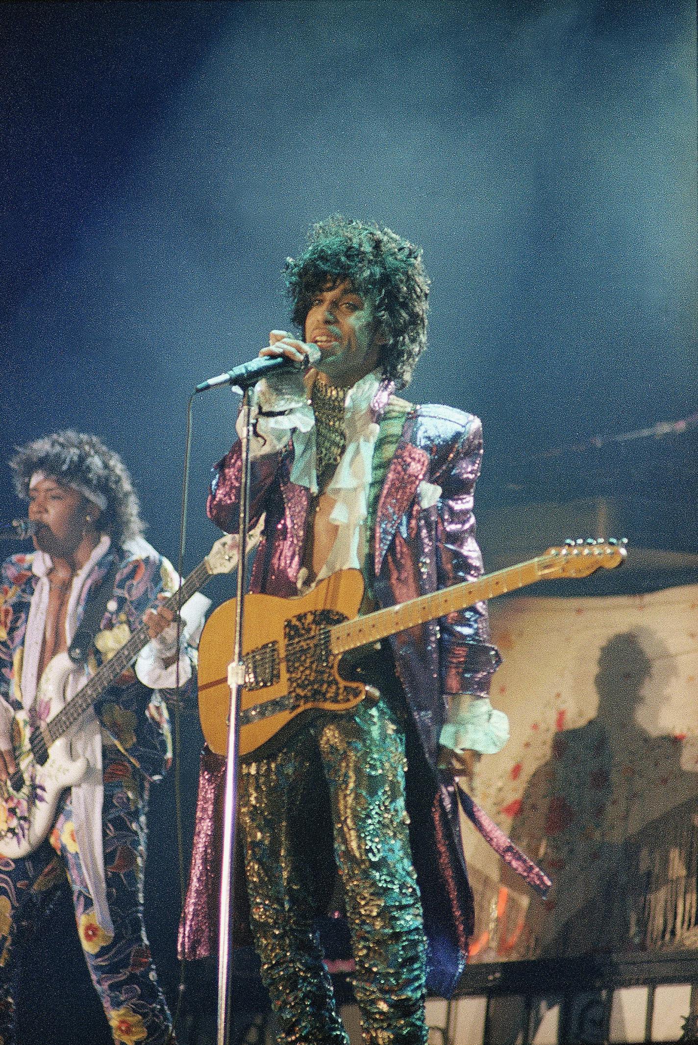 FILE - In this 1985 file photo, singer Prince performs in concert. The Revolution, the band that helped catapult Prince to international superstardom is reuniting in his memory. The Revolution, which backed up Prince in the 1980s, will play two shows Sept. 2-3, 2016, at First Avenue, the downtown Minneapolis nightclub where Prince and the Revolution filmed &#xec;Purple Rain.&#xee; (AP Photo/File)