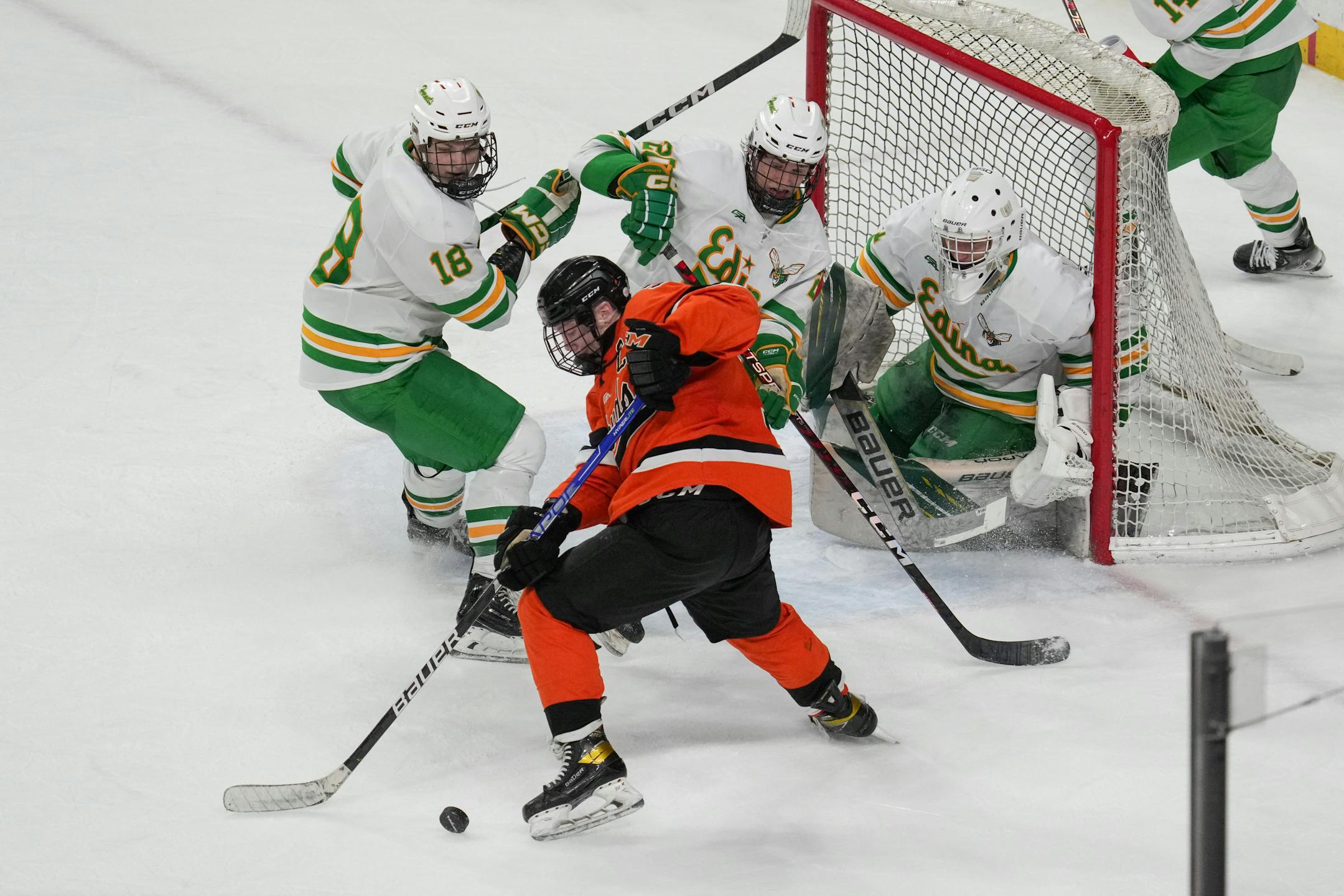 Edina's net was heavily guarded in the third period as Moorhead defenseman Colby Krier (5) reached for the puck during the MSHSL Class 2A quarterfinal hockey game between  Moorhead and Edina Thursday, March 9, 2023  St. Paul, Minn.