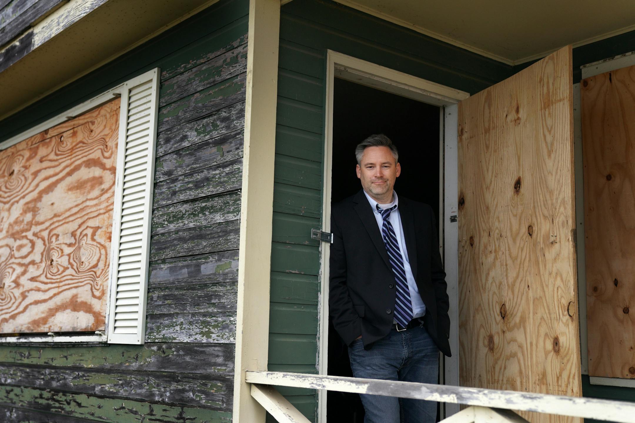 Dan Gustafson with the Heritage Preservation Board stood for a portrait on the porch of the 1902 Section Foreman House, a possible candidate for the National Register of Historic Places where the railroad foreman used to live, Thursday in Wayzata.