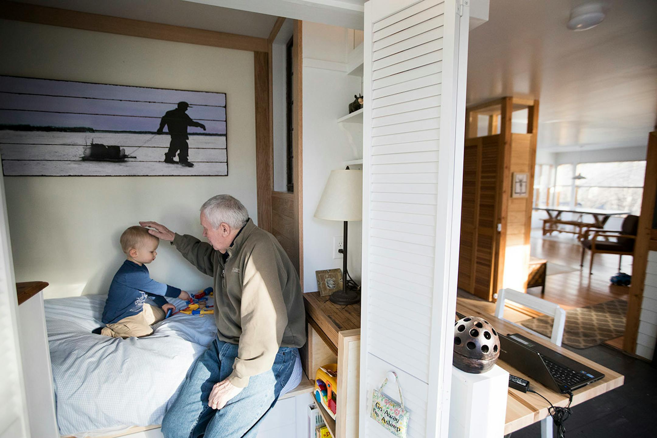 Al Hermansen plays with his grandson Matthew Mikkelson, 2, in the tiny cupboard bed he built for him in Hermansen's Excelsior home.