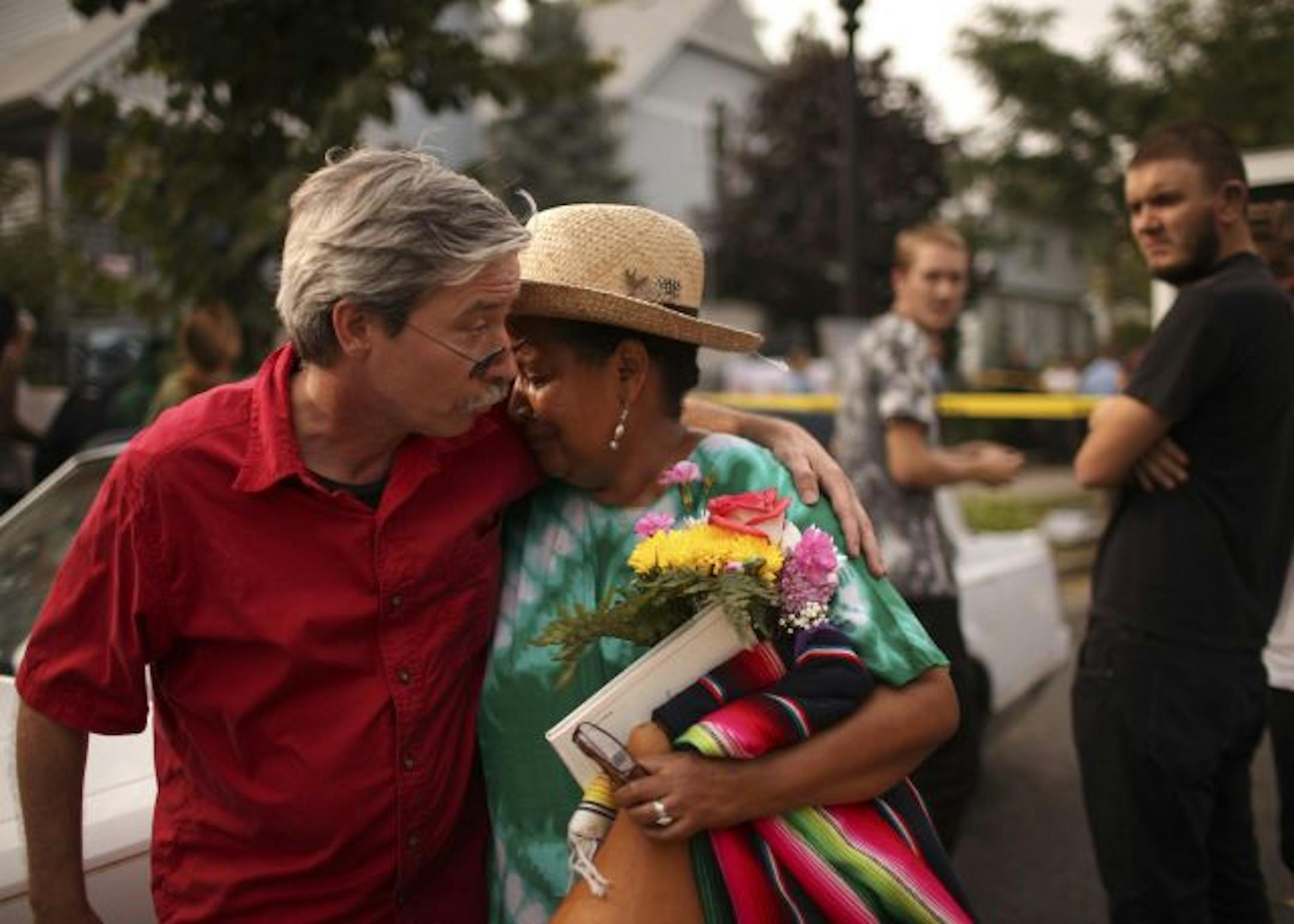 Rosemary Williams was comforted by Michael Hugh Kelly after she left her home behind late Friday afternoon. Kelly was arrested with other protesters a short time later.