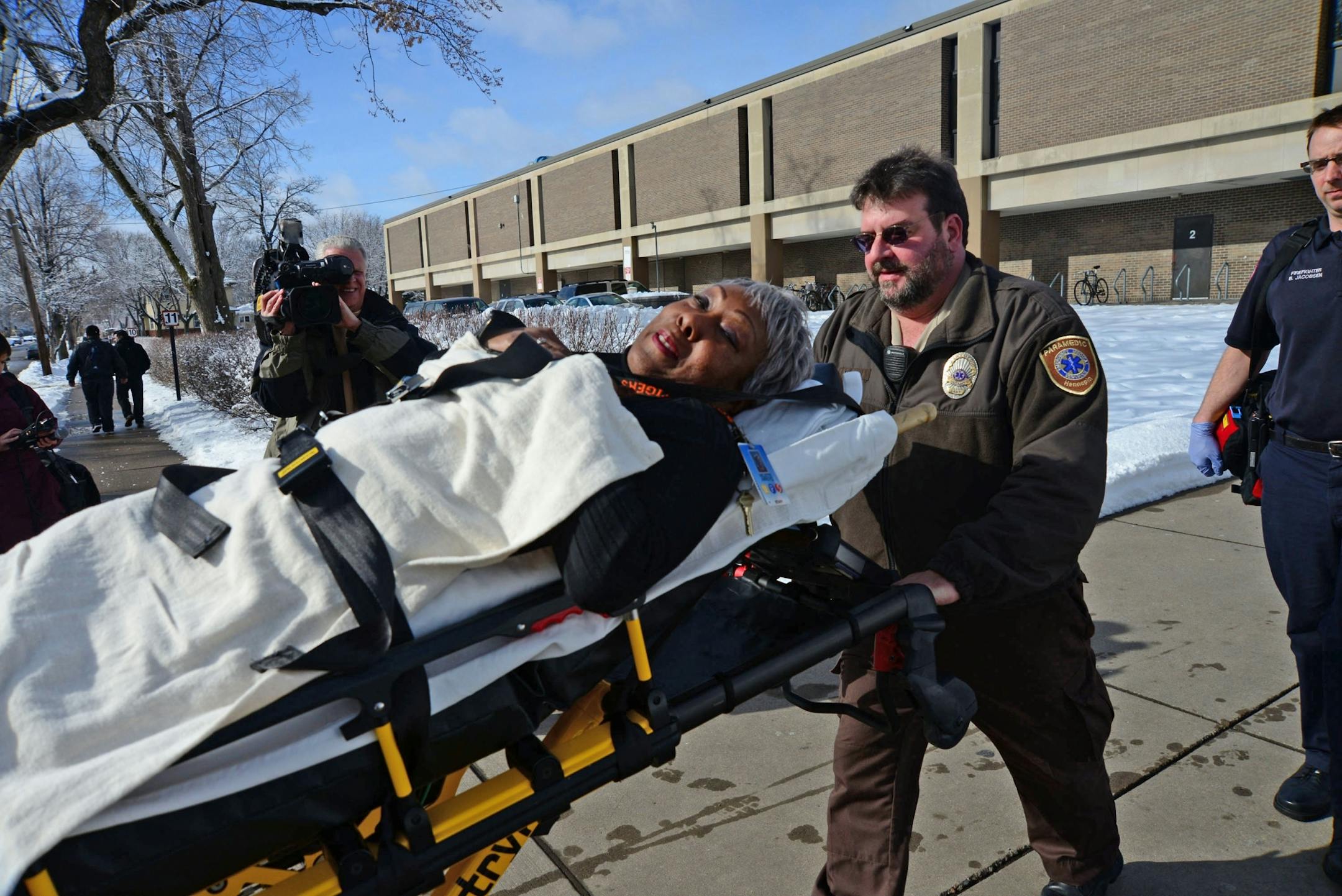 A person leaves South High School in Minneapolis on a stretcher after a fight brought ambulances and police to the school on Thursday, Feb. 14, 2013.