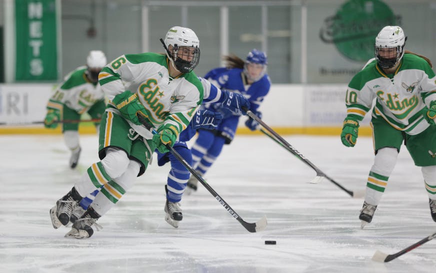 Edina's Emma Conner (16) carries the puck into the offensive zone against Minnetonka Tuesday night. Conner had a goal in the Hornets' 3-2 victory over the Skippers at Braemar Arena in Edina. Photo by Jeff Lawler, SportsEngine