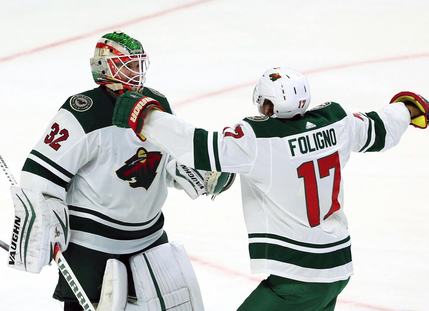 Wild goaltender Alex Stalock and Marcus Foligno celebrated after Stalock made 26 saves in defeating the Ottawa Senators 2-0 on Monday, earning the Wild its first victory of the season.