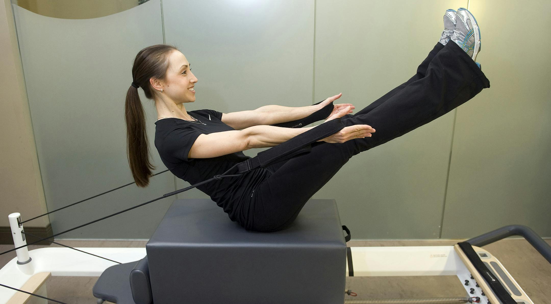 Personal trainer Robyn Baker performs a Pilates Teaser exercise at the Healthfit 4 Life studio at Personal Care Physicians in Newport Beach, California. (Paul Bersebach/Orange County Register/MCT) ORG XMIT: 1135002