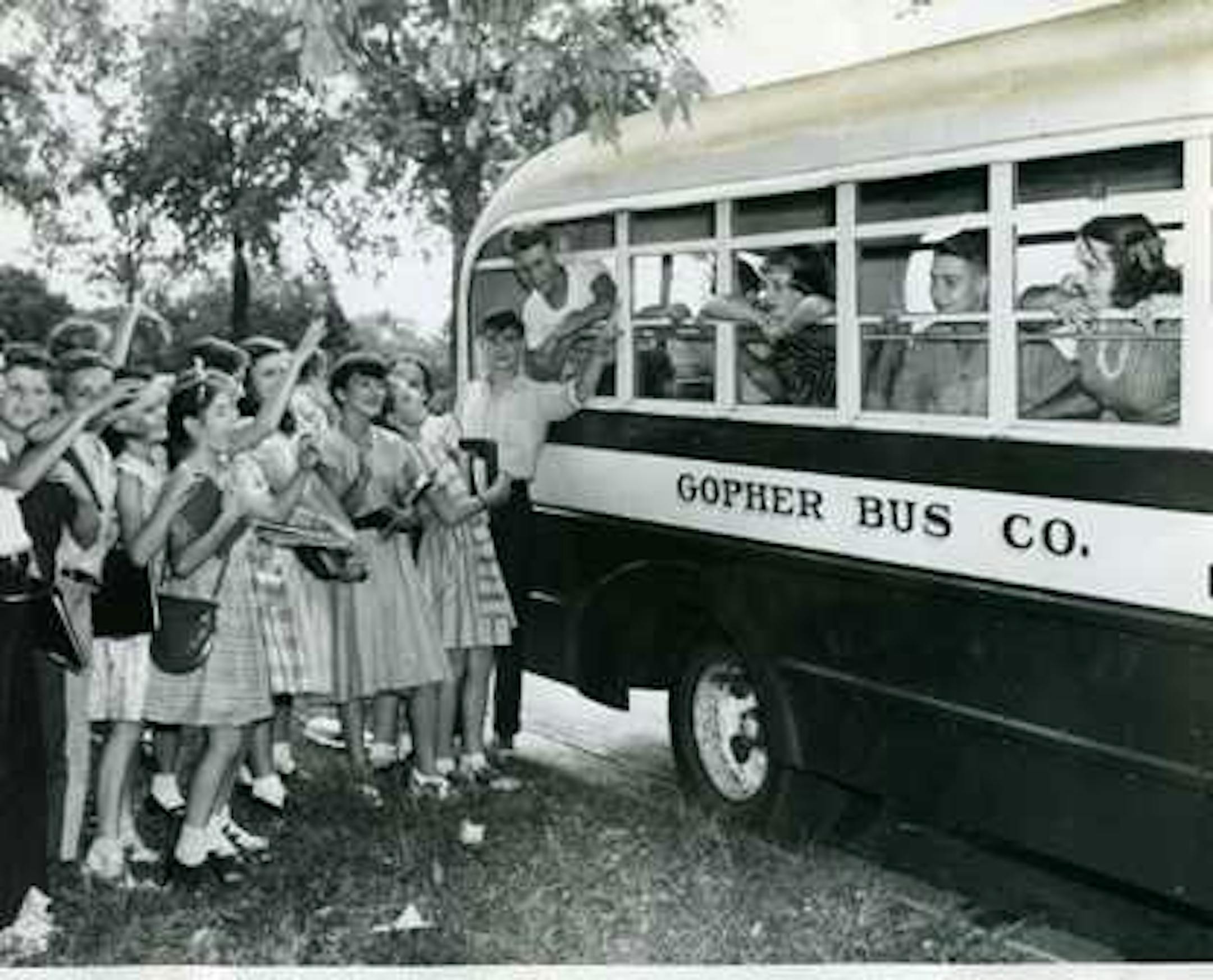 1946: Fort Snelling kids go to Washburn and Ramsey schools here in Minneapolis - Ramsey kids outside bus wave bye bye to the five lone Washburn High kids (Minneapolis Morning Tribune)
