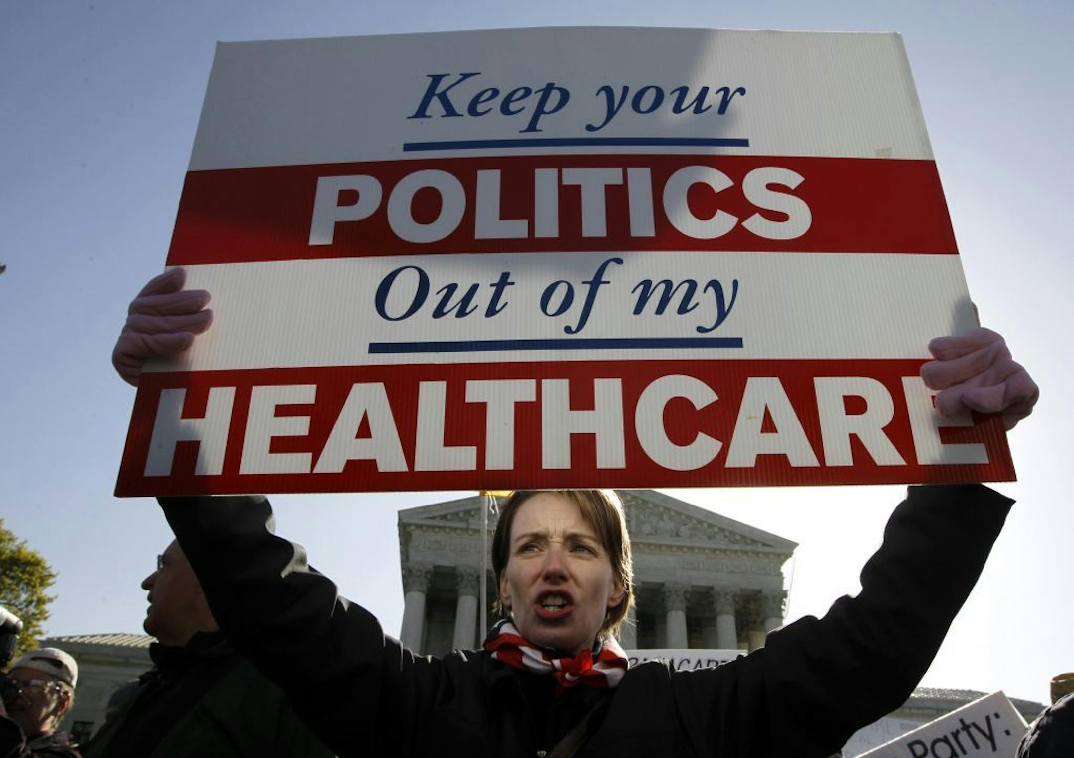 FILE - In this March 27, 2012, file photo, Amy Brighton of Medina, Ohio, who opposes health care reform, rallies in front of the Supreme Court in Washington. Health care was the defining political battle of President Barack Obama�s first term, and _ after the economy_ it remains his most complicated policy challenge at home, central to his place in history.