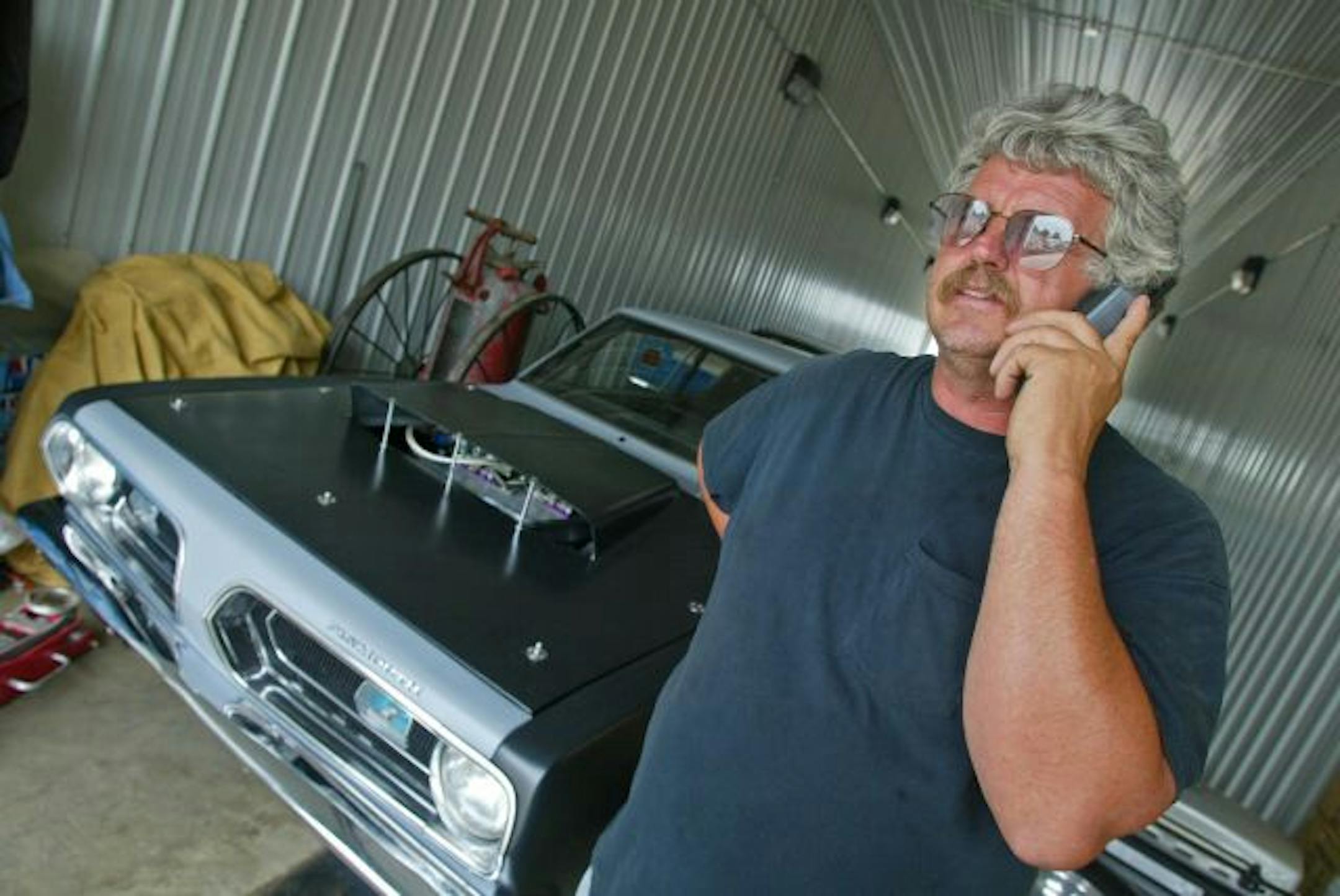 BRUCE BISPING � bbisping@startribune Bruce Bisping/Star Tribune. Elkton, MN., Tuesday, 7/25/2006. Fred Englehart of Englehart's Garage in tiny Elkton Minnesota is on the phone all the time tracking down the ultra rare 60's and 70's muscle cars he buys and sells.