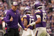 Kevin O’Connell celebrates with quarterback Joshua Dobbs (15) after Minnesota Vikings running back Ty Chandler (32) scored a touchdown in the second