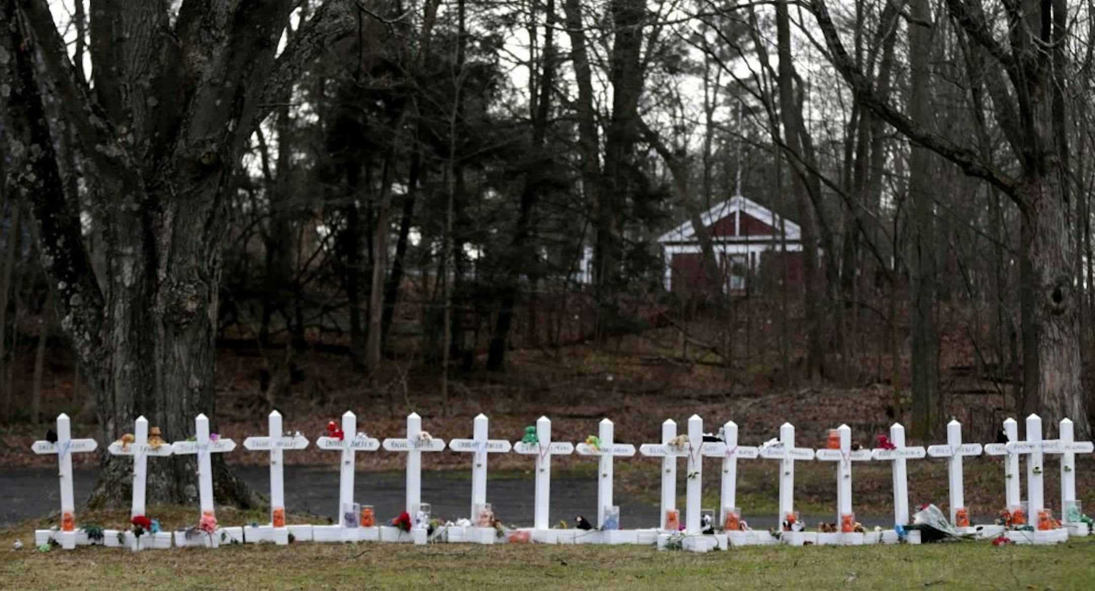 Crosses bearing the names of the Newtown shooting victims are displayed in the Sandy Hook village of Newtown, Conn., Saturday, Dec. 22, 2012. The funerals for the victims of the school shooting are wrapping up after a wrenching week of farewells. Twenty children and six adults were killed at Sandy Hook Elementary School on Dec. 14. Adam Lanza, the lone gunman, killed his mother before going on the rampage and then committed suicide.