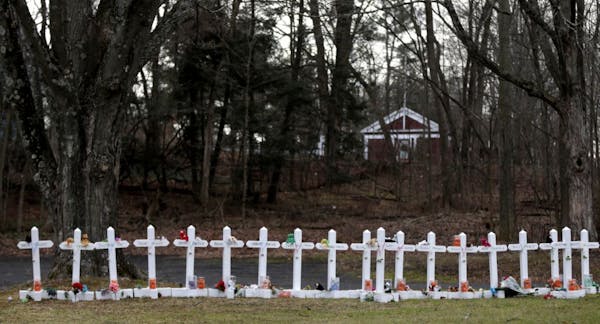 Crosses bearing the names of the Newtown shooting victims are displayed in the Sandy Hook village of Newtown, Conn., Saturday, Dec. 22, 2012. The fune