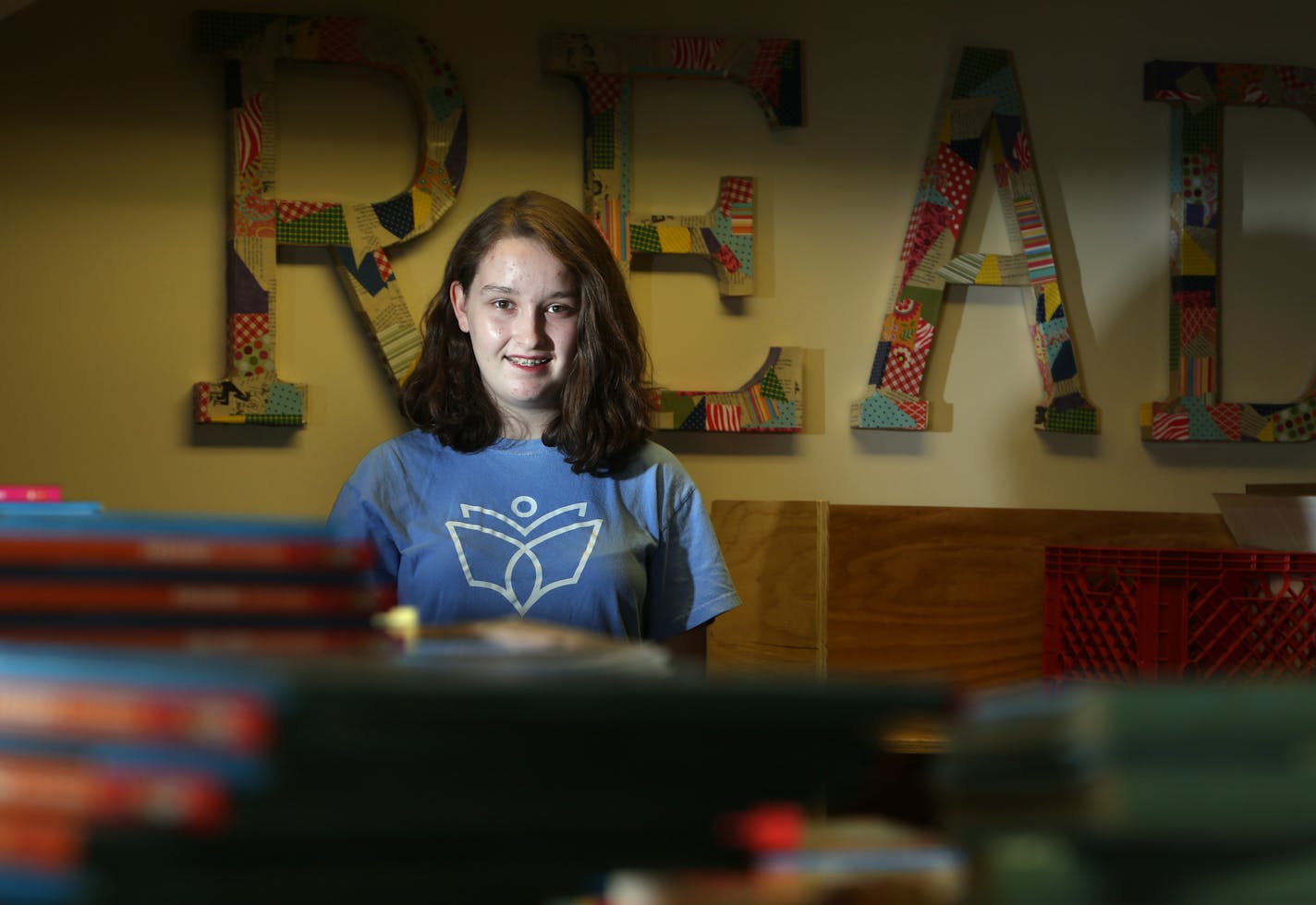 Maria Keller 14, at a warehouse in Hopkins where she collects thousands of books to distribute across Minnesota and the country to children in need Monday November 24 2014 in Hopkins, Minnesota. ] Jerry Holt Jerry.holt@startribune.com