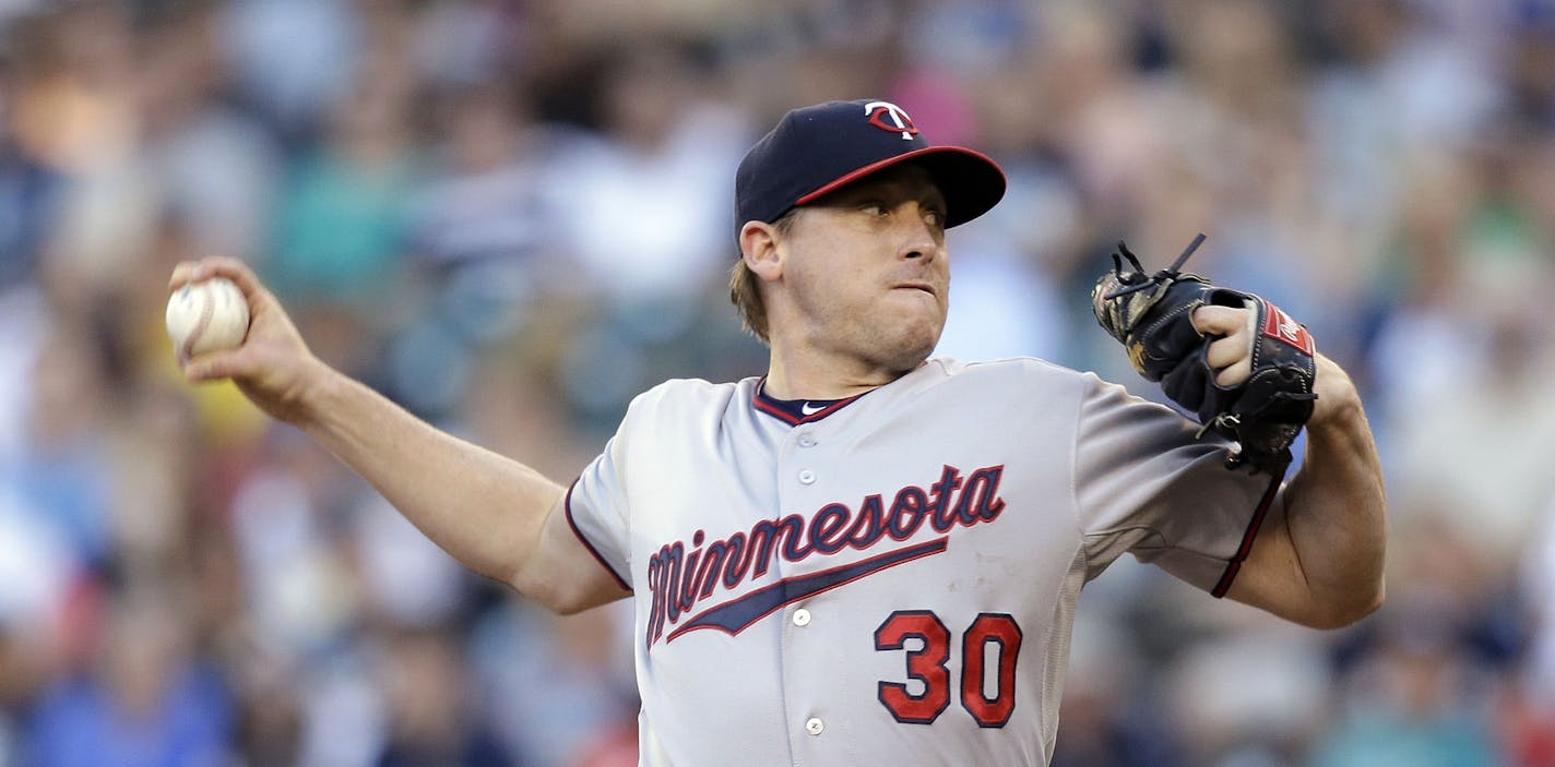 Minnesota Twins starting pitcher Kevin Correia throws against the Seattle Mariners in the first inning of a baseball game Monday, July 7, 2014, in Seattle. (AP Photo/Elaine Thompson)