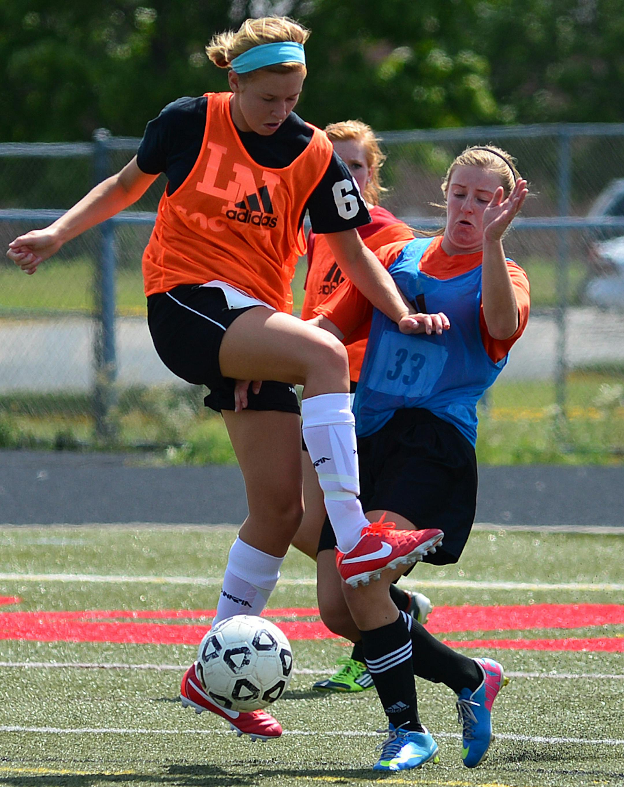 Lakeville North girls soccer team opened the fall season with the first day of practice on the main stadium field. Leah Pettit no 64 on the left and Stephanie Schaffer no 33 go for a ball during a scrimmage. ] Richard.Sennott@startribune.com Richard Sennott/Star Tribune Lakeville, Minnesota Monday 8/12/13) ** (cq)