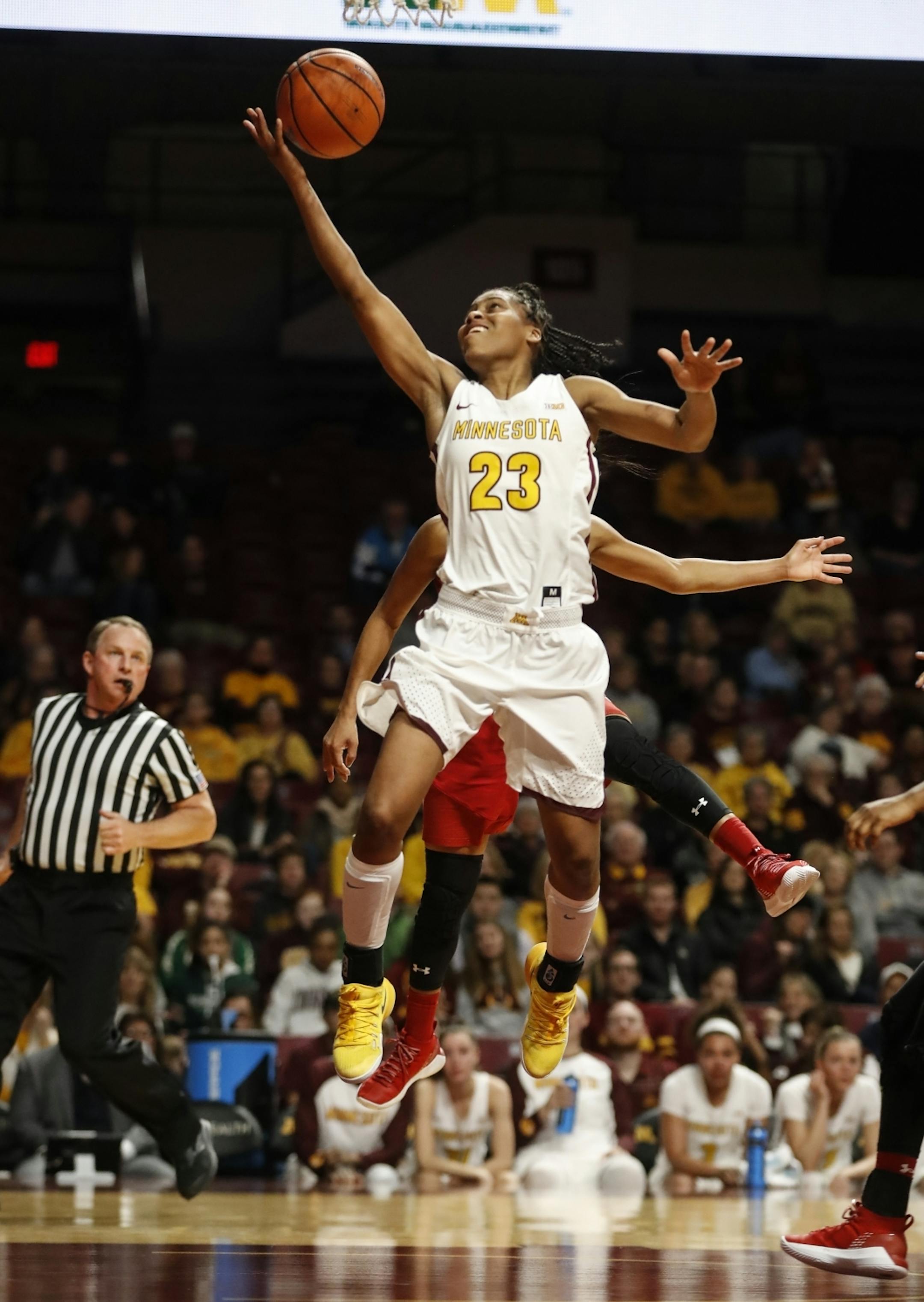 Minnesota Golden Gophers guard Kenisha Bell (23) jumped for a shot in the second half.