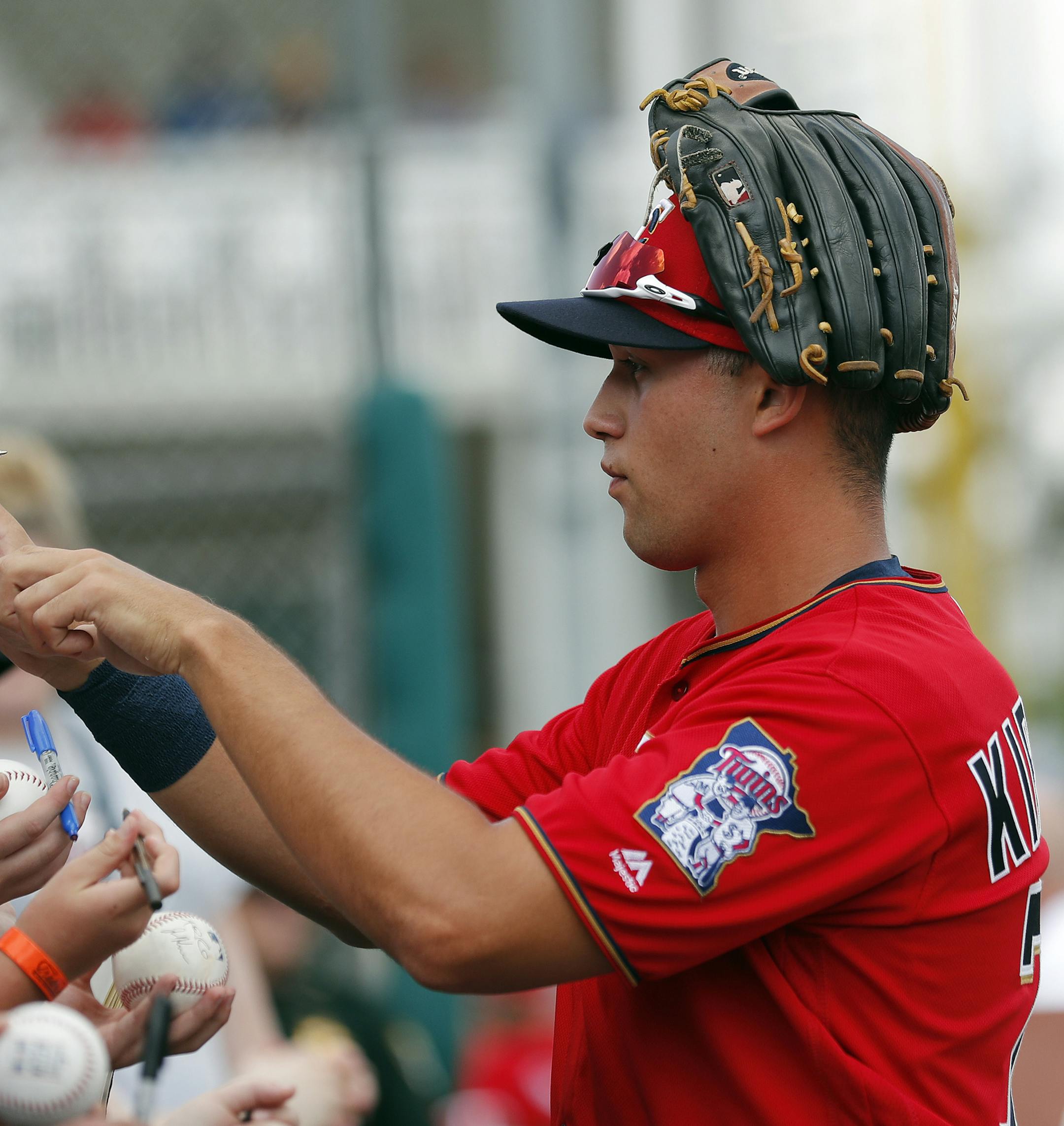 Minnesota Twins right fielder Alex Kirilloff signs autographs before the start of inning of a spring training baseball game against the Baltimore Orioles Monday, March 4, 2019, in Fort Myers, Fla. (AP Photo/John Bazemore) ORG XMIT: GAJB102