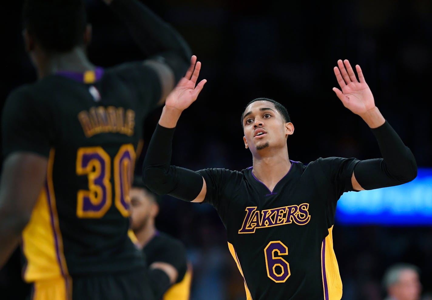 Lakers guard Jordan Clarkson, right, celebrated with forward Julius Randle after scoring against the Timnberwolves on Friday. Clarkson scored 35 points as the Lakers won 130-119 in overtime.