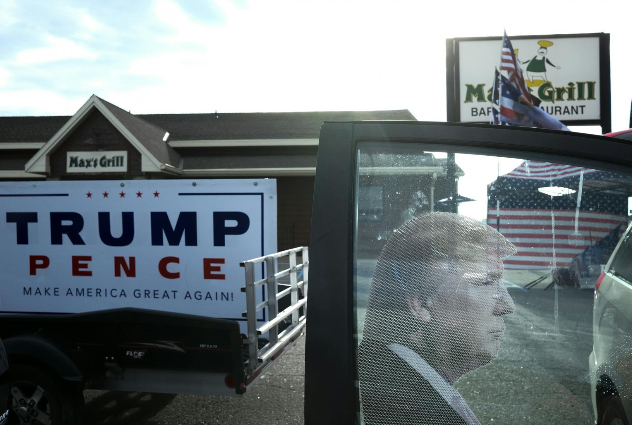 A decal of US President Donald Trump on the passenger side window of Randal Thom's minivan.