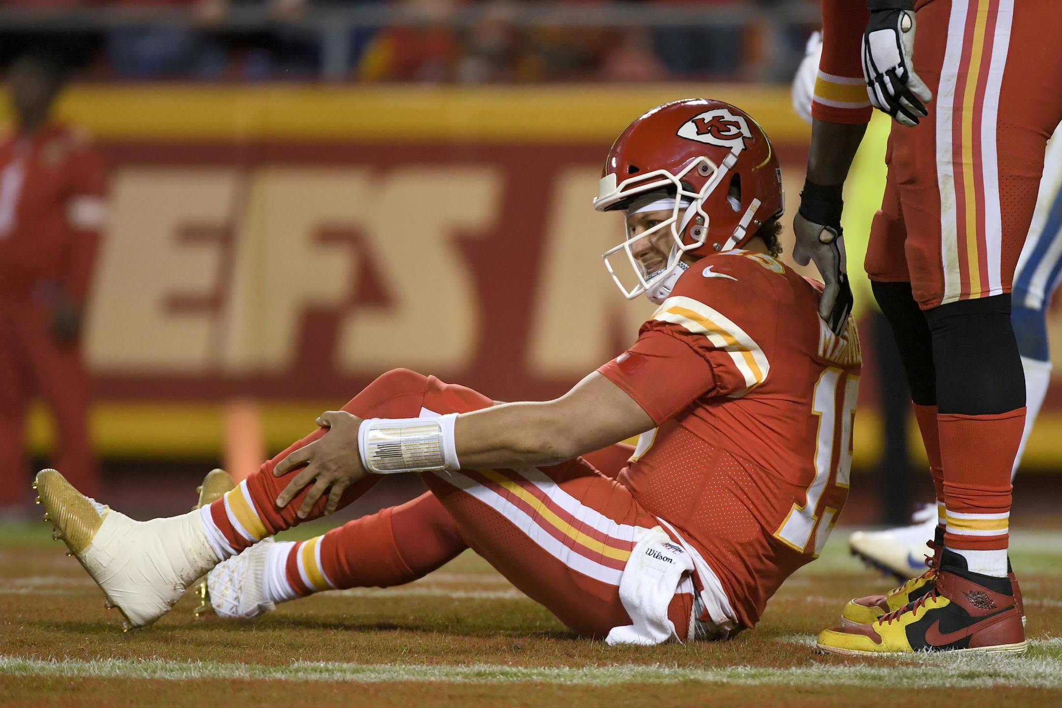 Kansas City quarterback Patrick Mahomes holds his leg after he was tackled by Colts defensive ends Kemoko Turay and Justin Houston on Oct. 6. Mahomes dislocated his knee 11 days later.