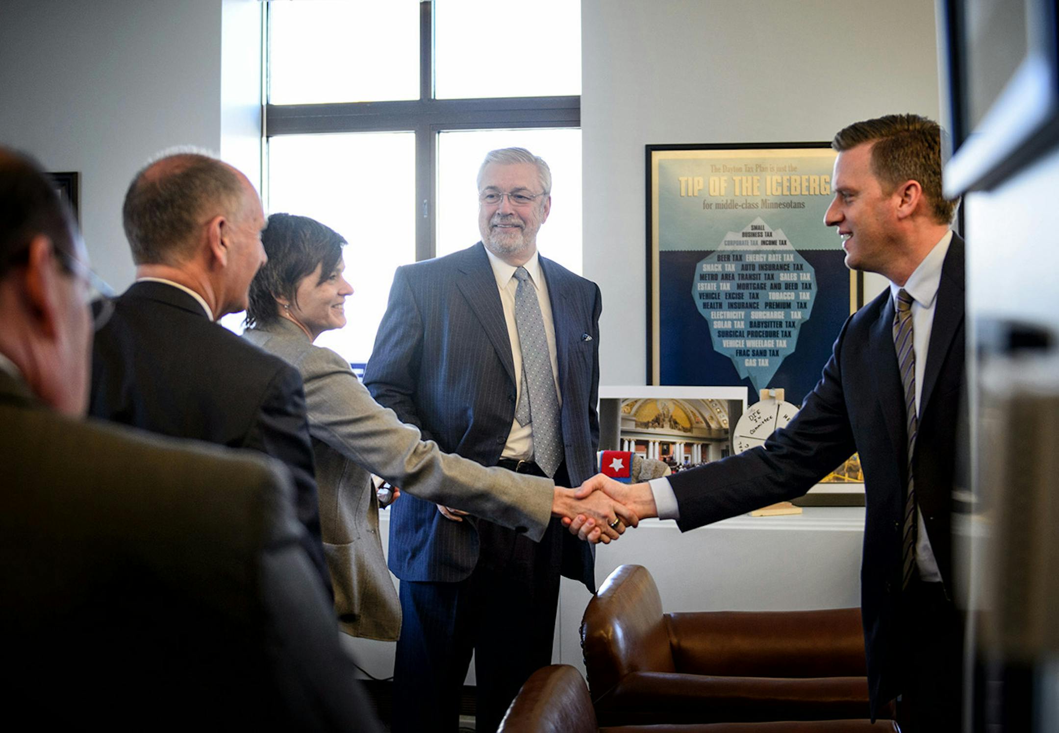 House Speaker Kurt Daudt, right, leaned in to shake hands with MLS board member Wendy Carlson Nelson in his office as Dr. Bill McGuire looked on. On the left is Timberwolves president Chris Wright.