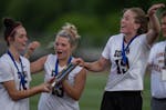 From left, Lakeville South's Sivanna O'Brien, Katie Grubbs and Tori Tschida celebrate a section championship that led to this week's girls lacrosse st
