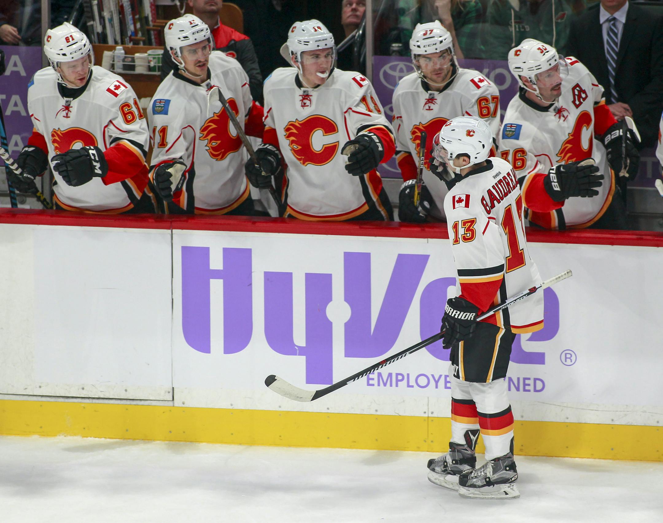 Calgary Flames left wing Johnny Gaudreau (13) is congratulated by teammates after he scored on a power play against the Minnesota Wild during the first period of an NHL hockey game, Tuesday, Nov. 15, 2016, in St. Paul, Minn. (AP Photo/Paul Battaglia)