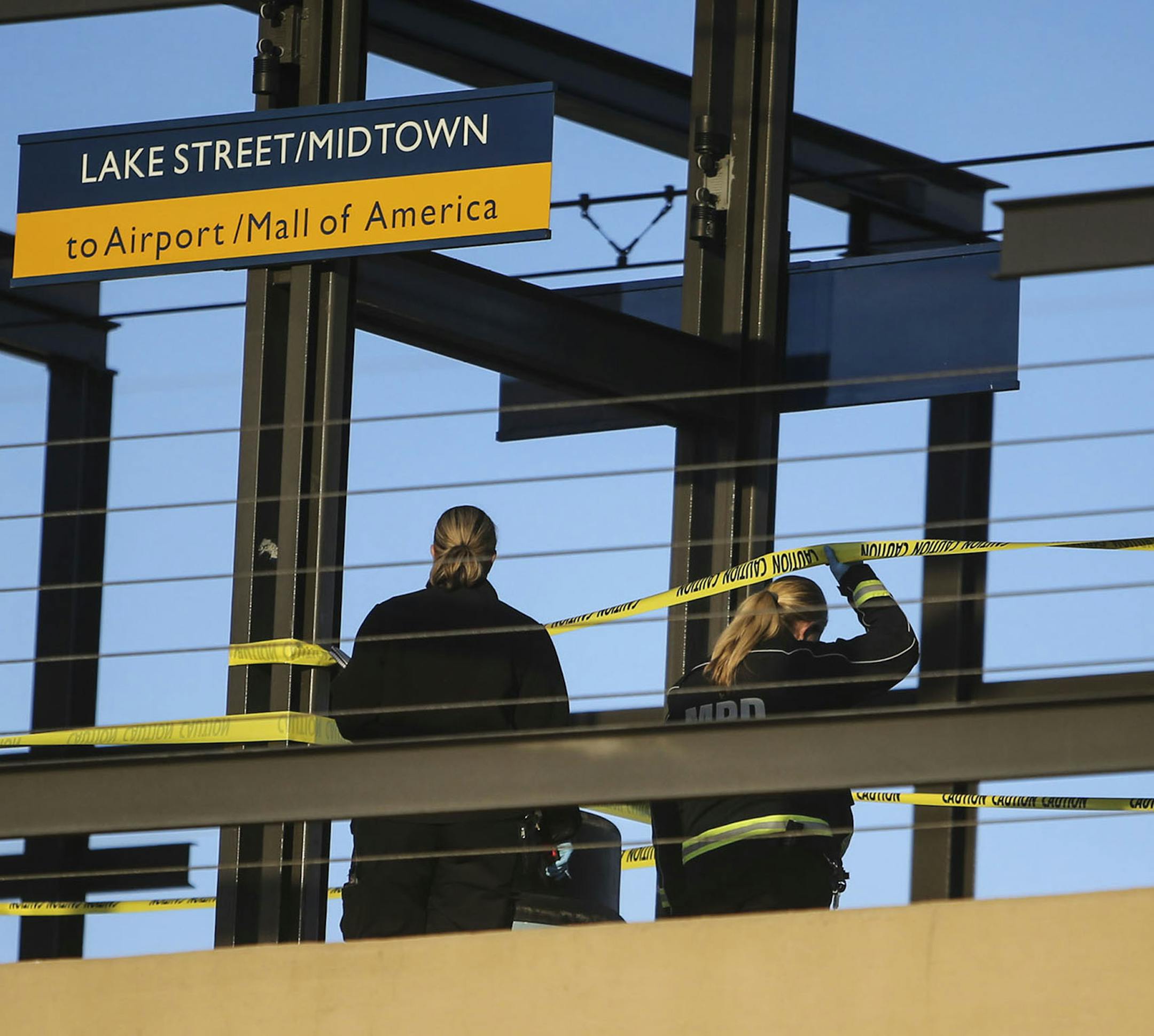 Police investigators go over the scene of an apparent homicide on the Midtown Lake Street light rail platform that shut down the station for a time during the afternoon Saturday, Dec. 6, 2014, in Minneapolis, MN.](DAVID JOLES/STARTRIBUNE)djoles@startribune.com An apparent homicide on the Midtown Lake Street light rail platform shut down the station for a time during the afternoon Saturday, Dec. 6, 2014, in Minneapolis, MN.