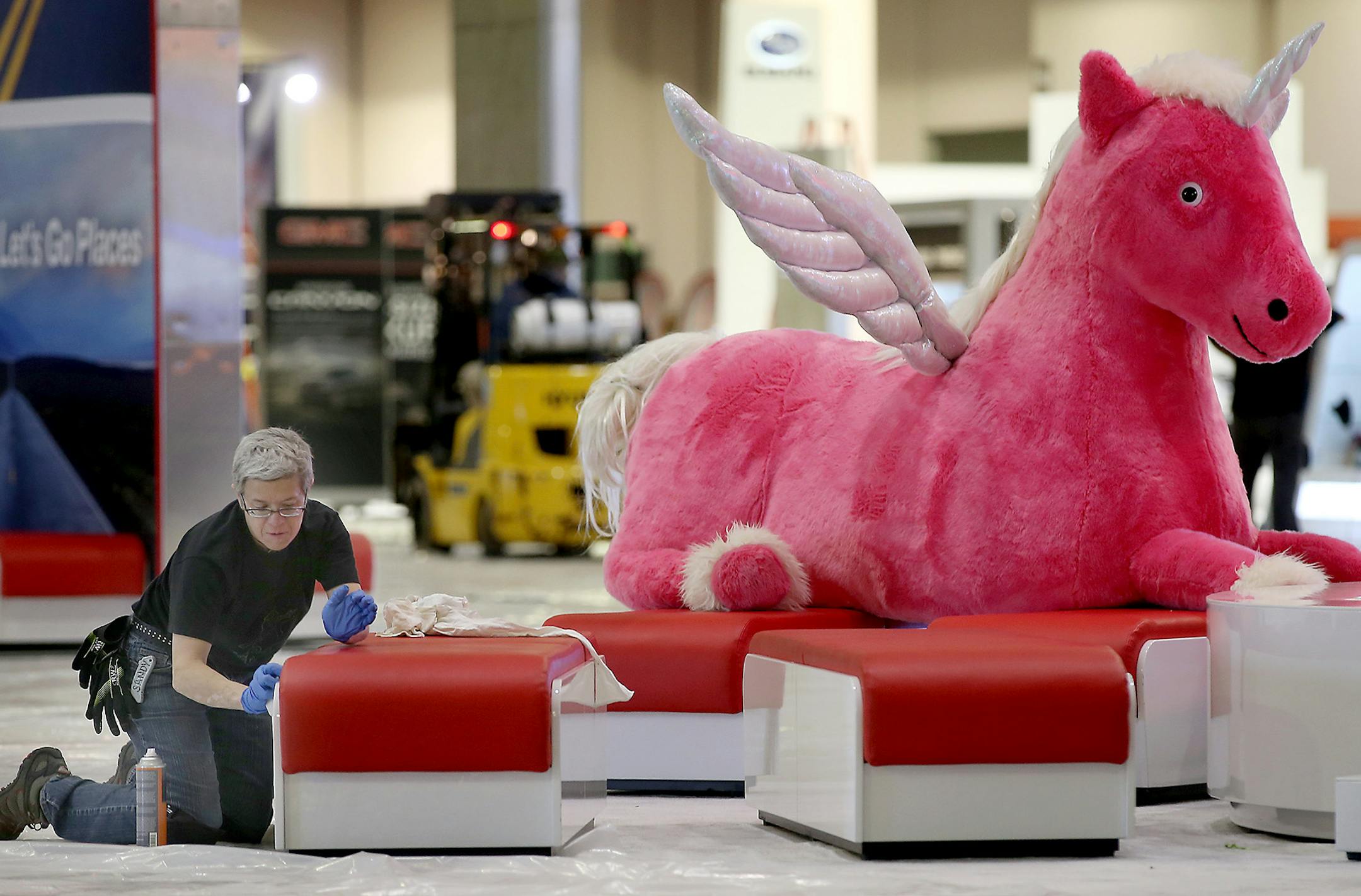 Sandy Talbott, cleaned the area near the Toyota booth as they set up for the annual Minneapolis auto show, Friday, March 6, 2015 in Minneapolis, MN. The show starts Saturday at the Minneapolis Convention Center. ] (ELIZABETH FLORES/STAR TRIBUNE) ELIZABETH FLORES • eflores@startribune.com