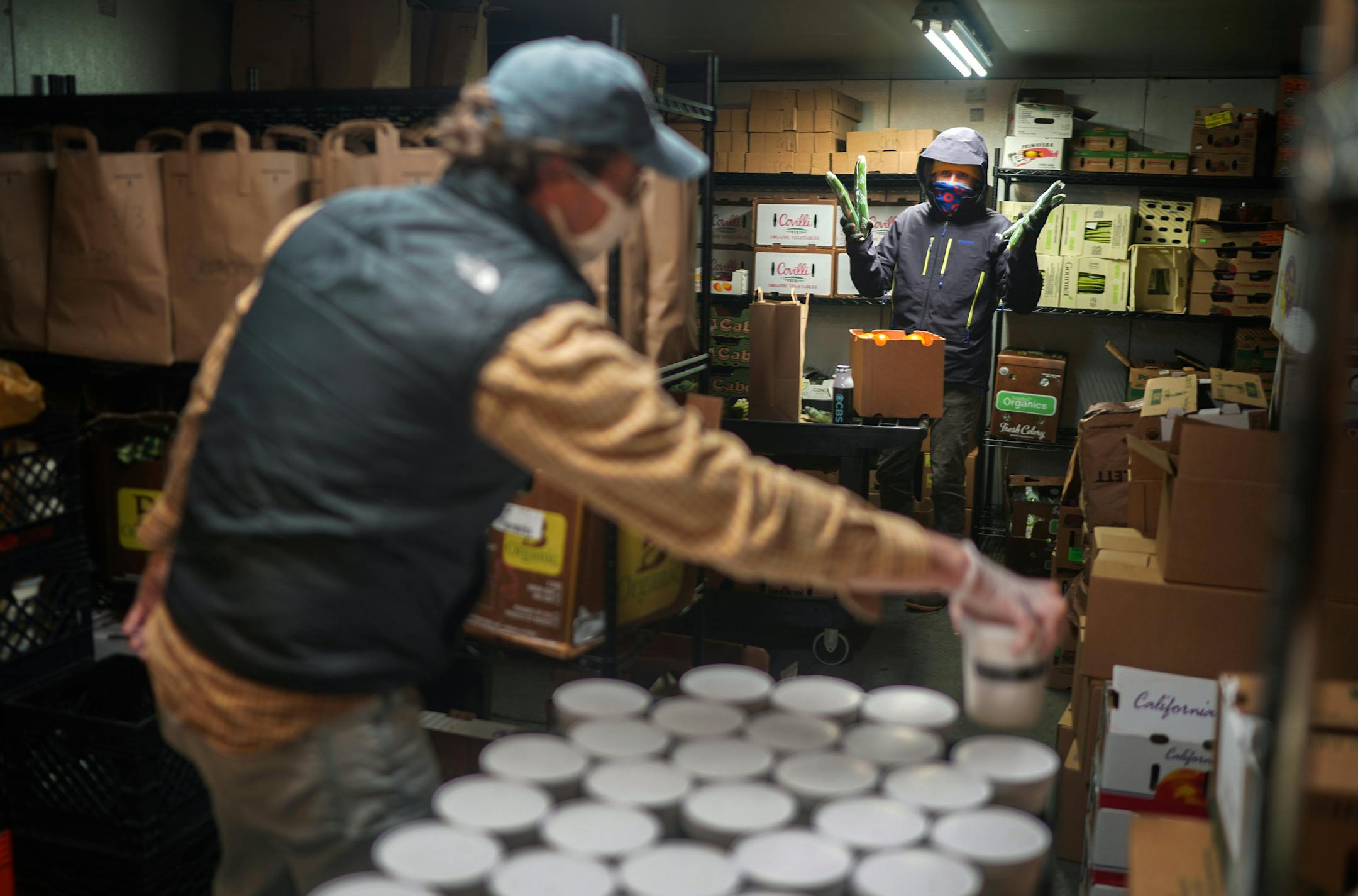 Employees sort through products in the refrigerator at Mike's Organic Delivery in Stamford, Conn., on May 12, 2020. With the uptick in demand, refrigerator space requires some organizational energy. (Chang W. Lee/The New York Times) ORG XMIT: XNYT38