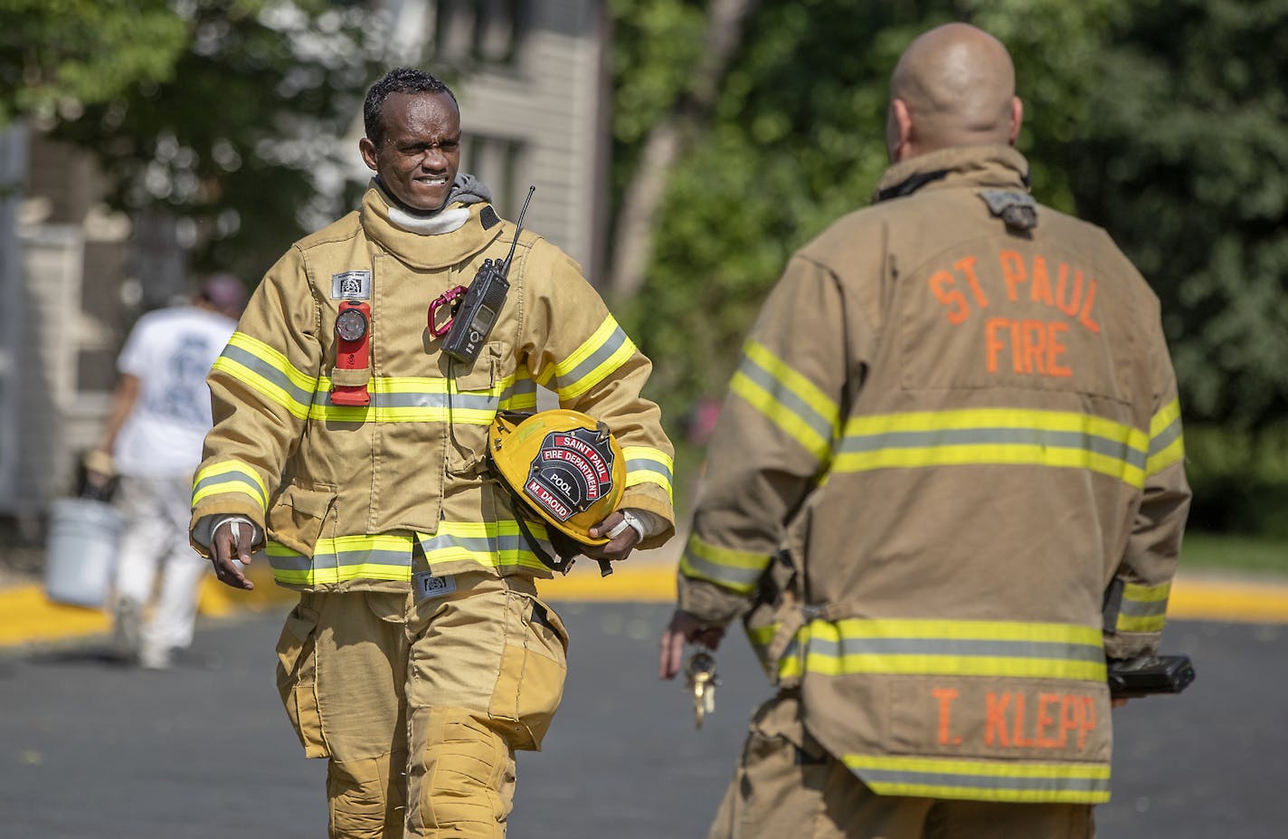 St. Paul firefighter Mohamed Daoud made his way out of a false alarm in an apartment complex along with Captain Tomo Klepp, cq, of Station 23 during his second day on the job as one of the first Somali Americans to be sworn into the St. Paul fire department. ] ELIZABETH FLORES &#x2022; liz.flores@startribune.com