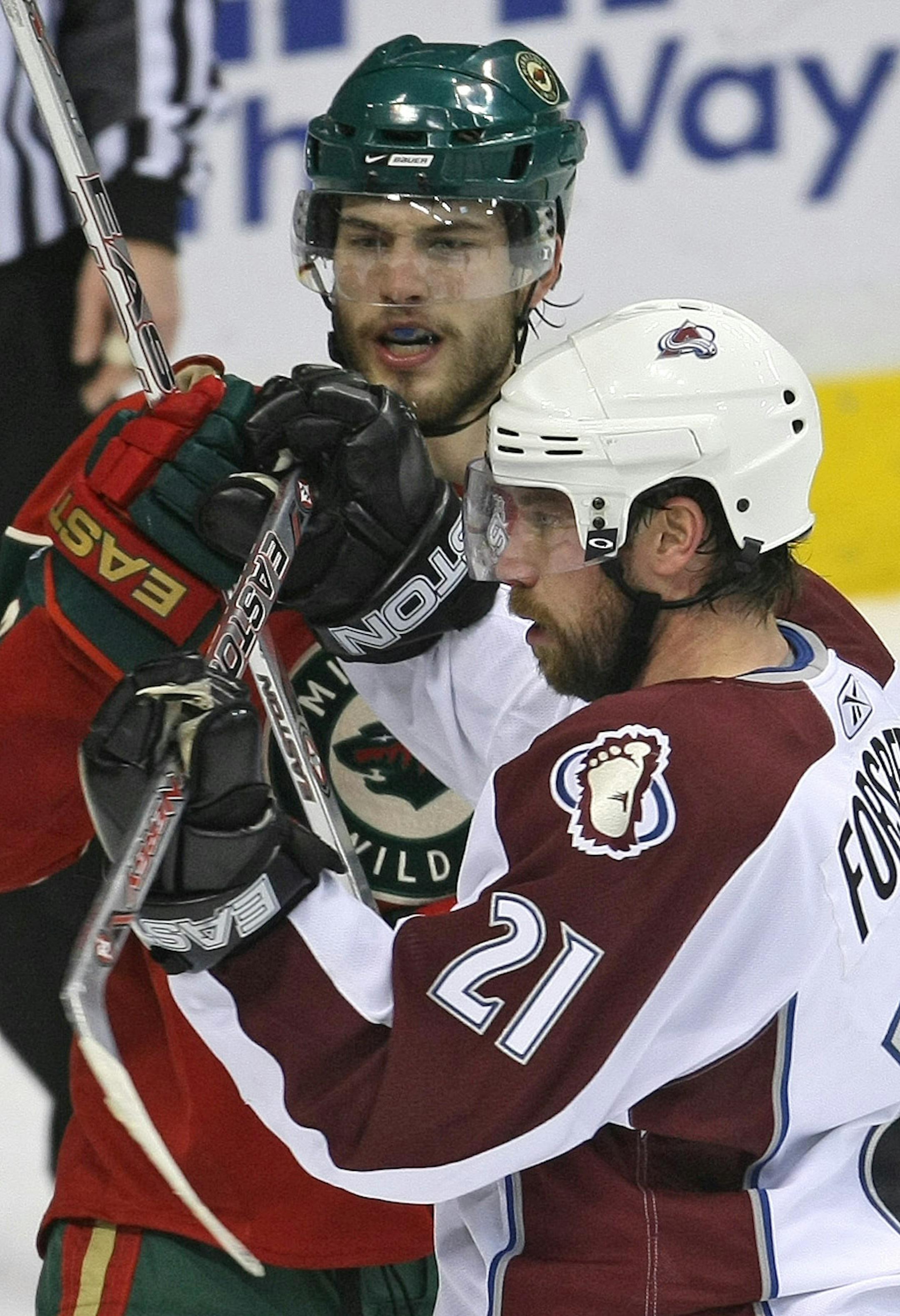 The Wild's Brent Burns (left) and Colorado's Peter Forsberg tangled in front of the Wild crease in the second period Monday. Forsberg is a superstar working his way back. Burns is a youngster making his mark.
