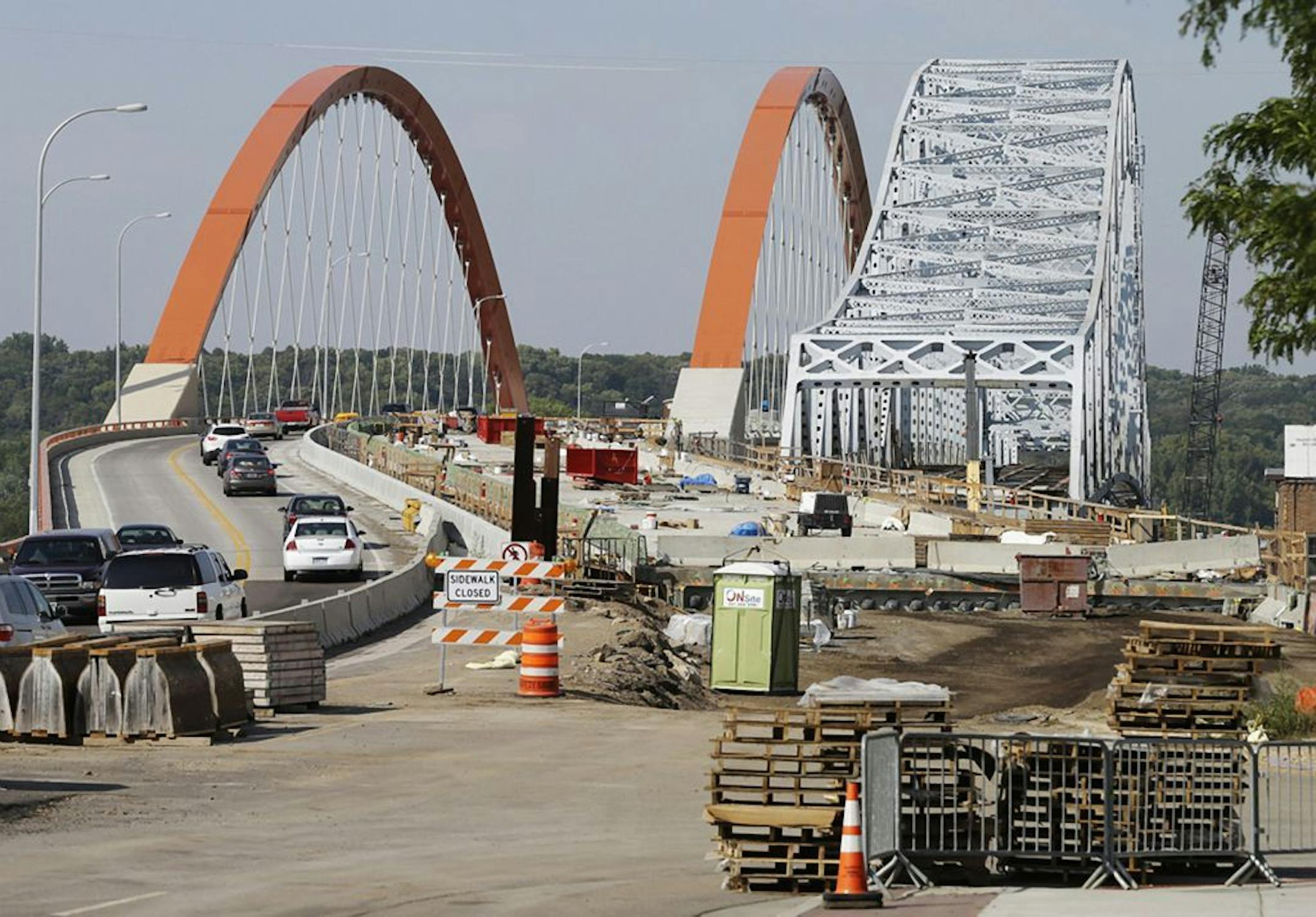 The partially dismantled old bridge remains at right as a work continues on the new bridge across the Mississippi River in Hastings, Minn. on Monday, Sept. 9, 2013. The two bridges that, for now, span the river side by side show an aggressive push in Minnesota to deal with deteriorating bridges after the 2007 collapse in Minneapolis.